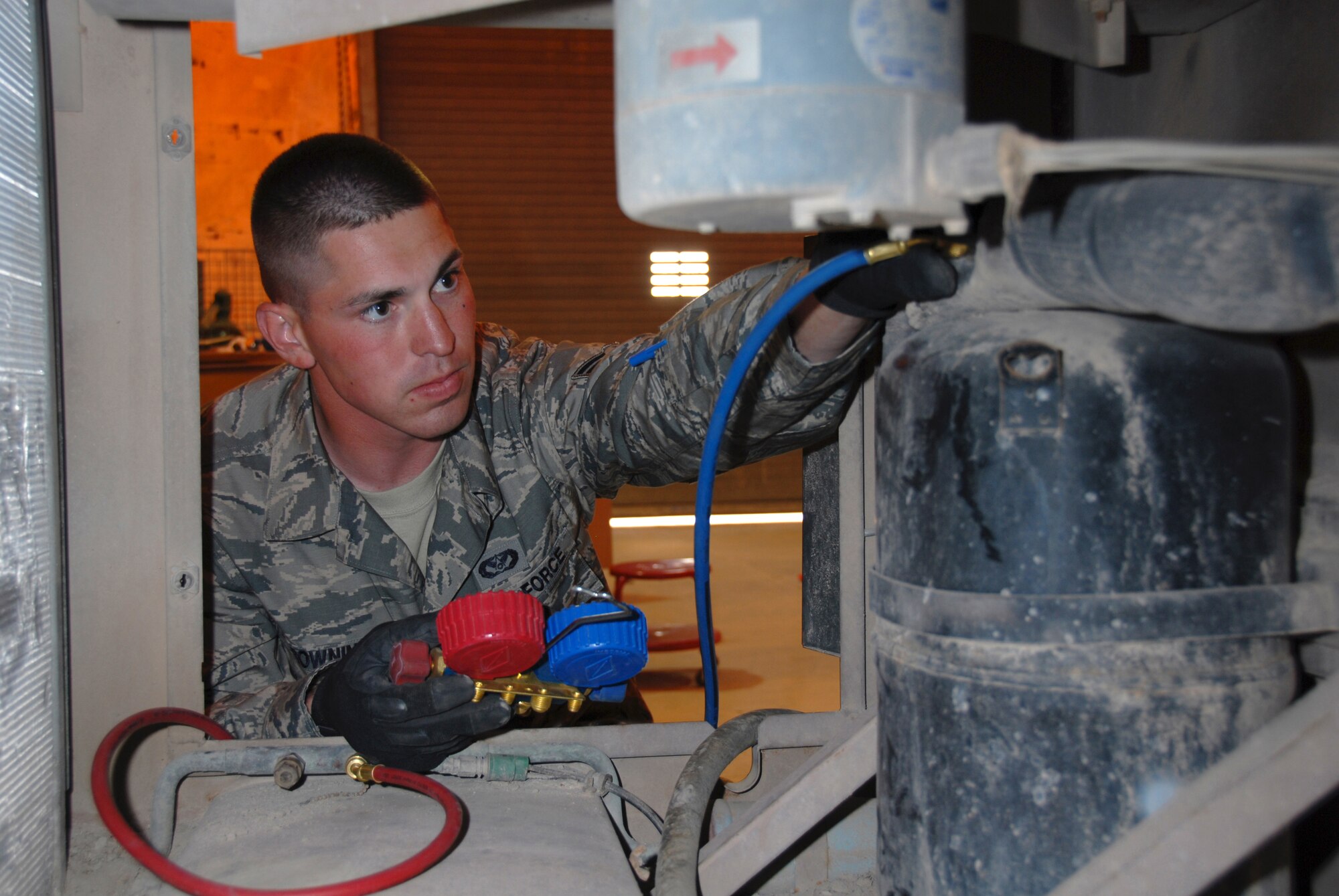 Airman 1st Class Matthew Browning, 379th Expeditionary Civil Engineer Squadron heating, ventilation, and air conditioning journeyman, pressurizes an environmental control unit here, Aug. 9. Airman Browning is a native of Oklahoma City, Okla., and is deployed from RAF Lakenheath, England, in support of Operations Iraqi and Enduring Freedom.  (U.S. Air Force Photo/Tech. Sgt. Jason W. Edwards) 