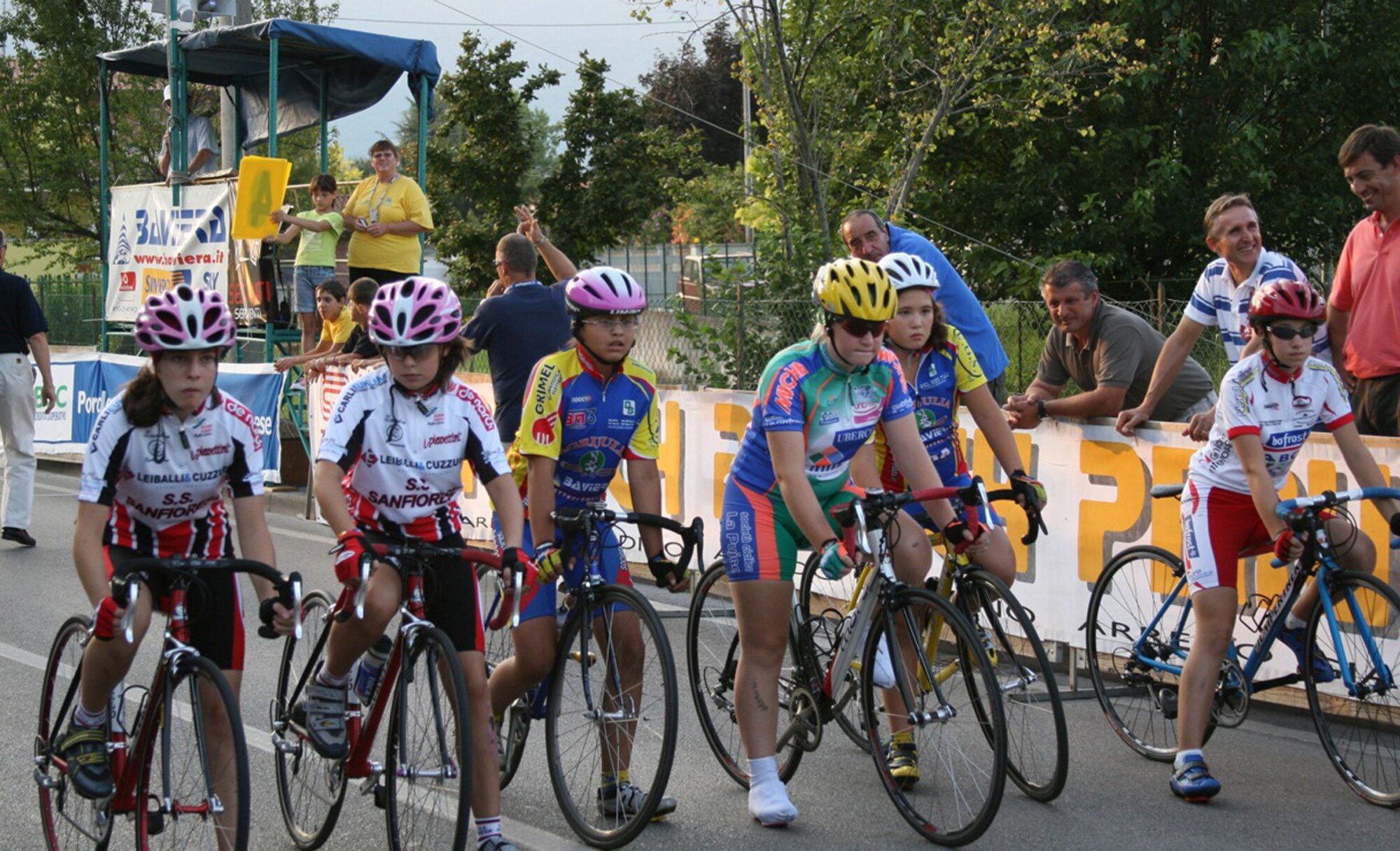 Kameron Sandoval (third from right), 11-year-old daughter of Master Sgt. Levi and Brenda Sandoval, 31st Operations Support Squadron, and Kieran Fritzsche, 11-year-old daughter of Master Sgt. Christopher and Nelly Fritzsche, 31st Civil Engineer Squadron, line up for the start of the Notturna dell 'Assunta Trofeo B.C.C. Pordenonese race Aug. 7 in Vigonovo, Italy. The event was a scratch style race, which is a high paced race with a sprint finish. The girls, who are members of the Societa Ciclistica Fontanafredda youth bicycle team, placed fifth and seventh in the G-6 (11-year-old) category respectively. (U.S. Air Force photo/Master Sgt. Levi Sandoval)