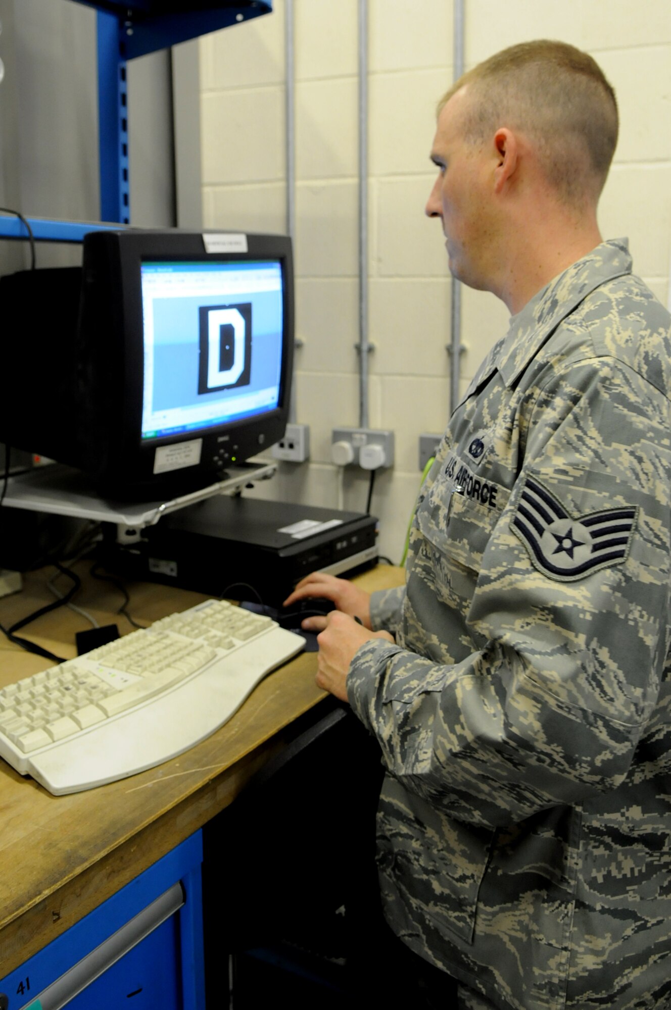 RAF MILDENHALL, England -- Aircraft Structural Maintenance craftsman Staff Sgt. Christopher Breaux creates the digital file used to print the “Box D” decal seen on the tail of 100th Air Refueling Wing KC-135s.  The sergeant can create any decal needed for any aircraft or piece of equipment at RAF Mildenhall.   (U.S. Air Force photo by Staff Sgt. Austin M. May)