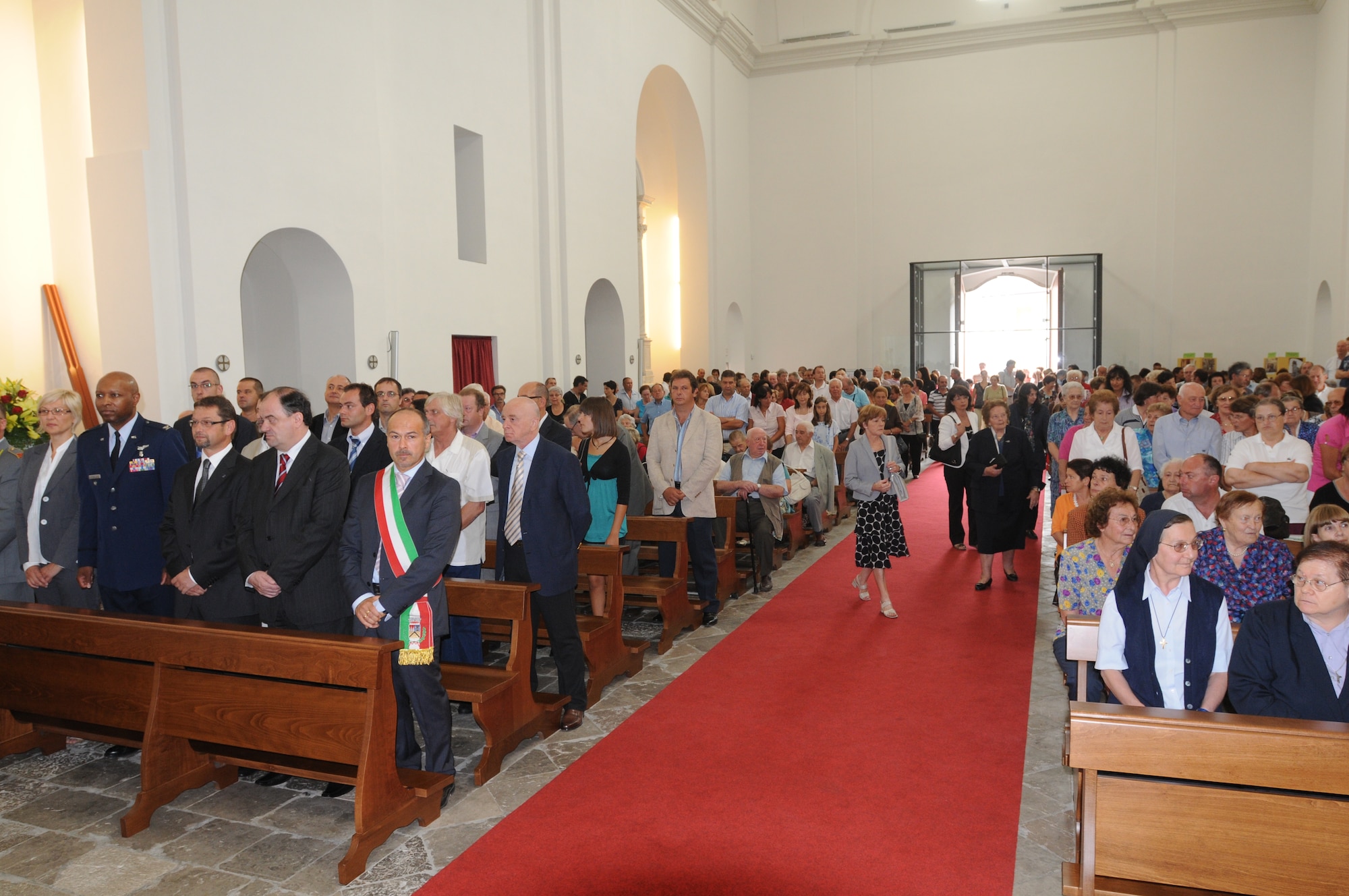 The townspeople of Forgaria nel Friuli and invited guests fill the San Lorenzo Martire Church for a holy mass Aug. 9, 2009, officiated by Monsignor Pietro Brollo, bishop of Udine.  Col. Donald Cole, 31st Medical Group deputy commander, represented the U.S. Air Force.  The holy mass marked the end of a 33-year project to rebuild all the churches in the Friuli-Venezia Giulia region damaged by the 1976 earthquakes and a new beginning for the townspeople who no longer have to go elsewhere to worship.  (U.S. Air Force photo/Staff Sgt. Patrick Dixon)