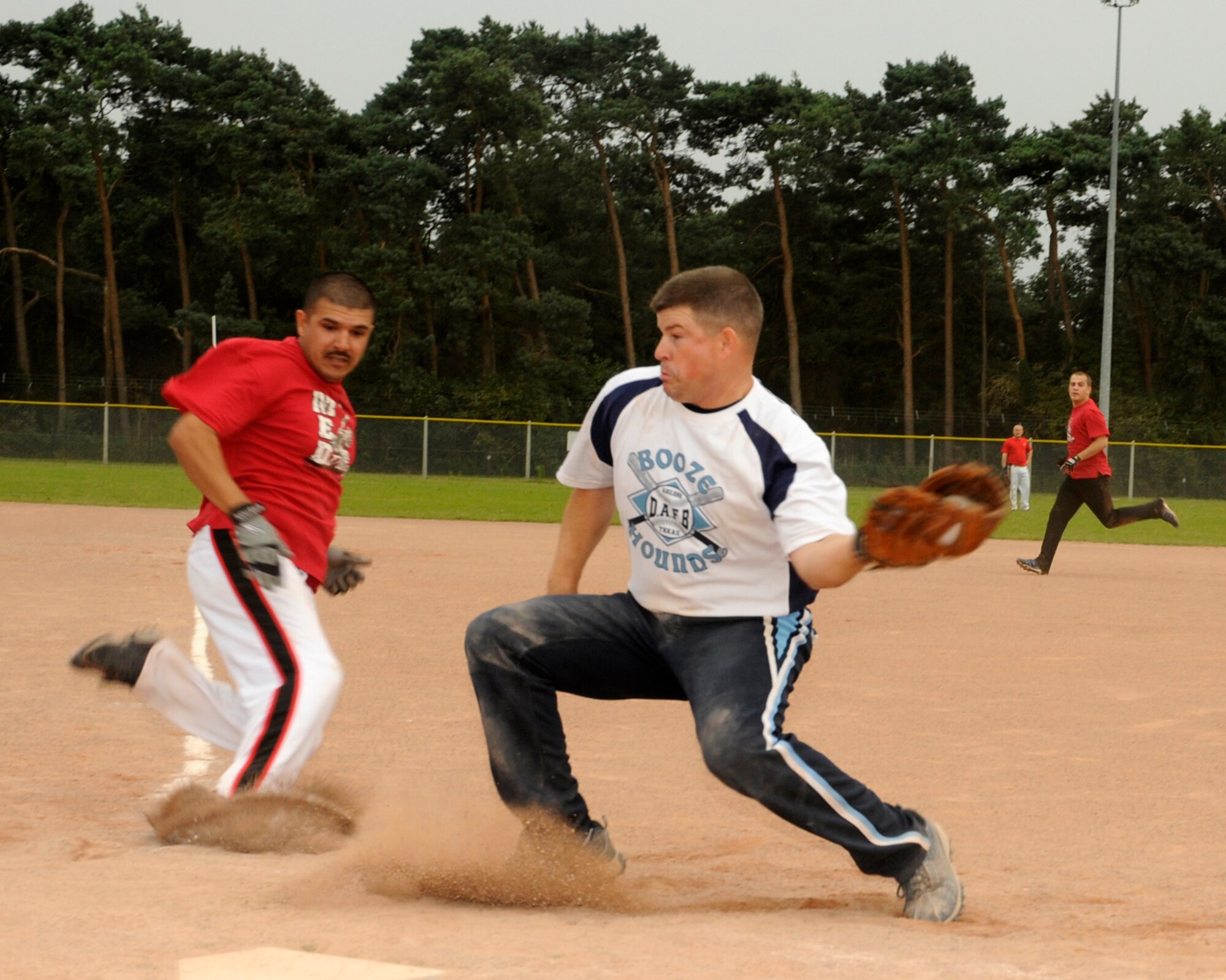 Sergio Heras of the 48th Medical Groups Med Dawgs slides safely into home-plate as Jimmy Hedden of the 48th Munitions Squadron’s Arms Shop attempts to tag Heras out during the intramural softball championship game August 6, 2009, at RAF Lakenheath, England. This was just one of many plays that led the Med Dawgs to a 14 to 11 victory over the Arms Shop. (U.S. Air Force photo/Airman 1st Class Eboni Knox)