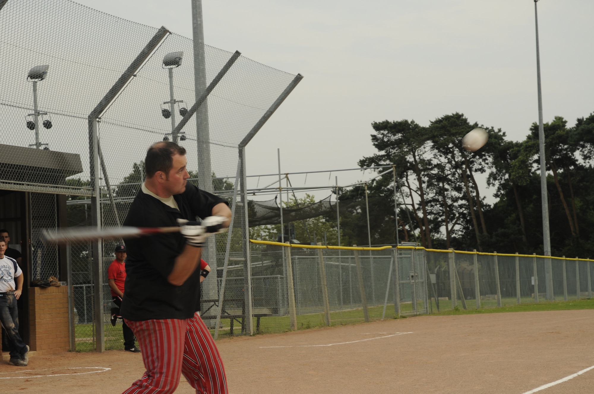 Chris Patton of the 48th Munitions Squadron’s Arms Shop swings at a fair pitch after two balls during the intramural softball championship game against the 48th Medical Group’s Med Dawgs on August 6, 2009, at RAF Lakenheath, England. The Arms Shop claimed the victory in the first game, but was unable to maintain their momentum in the second, relinquishing the championship to the Med Dawgs. (U.S. Air Force photo/Airman 1st Class Eboni Knox)