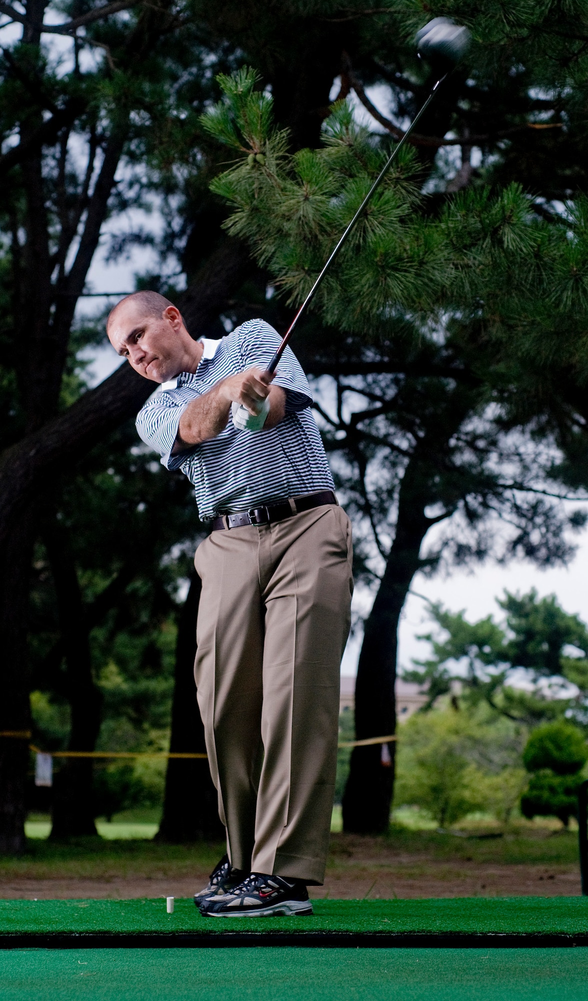 KUNSAN AIR BASE, Republic of Korea -- Capt. Andy "Wedge" Aduddell, 8th Fighter Wing, practices his golf swing.  Captain Aduddell received his call sign "Wedge" because he was a professional golfer prior to being a pilot. (U.S. Air Force photo/Senior Airman Jonathan Steffen)