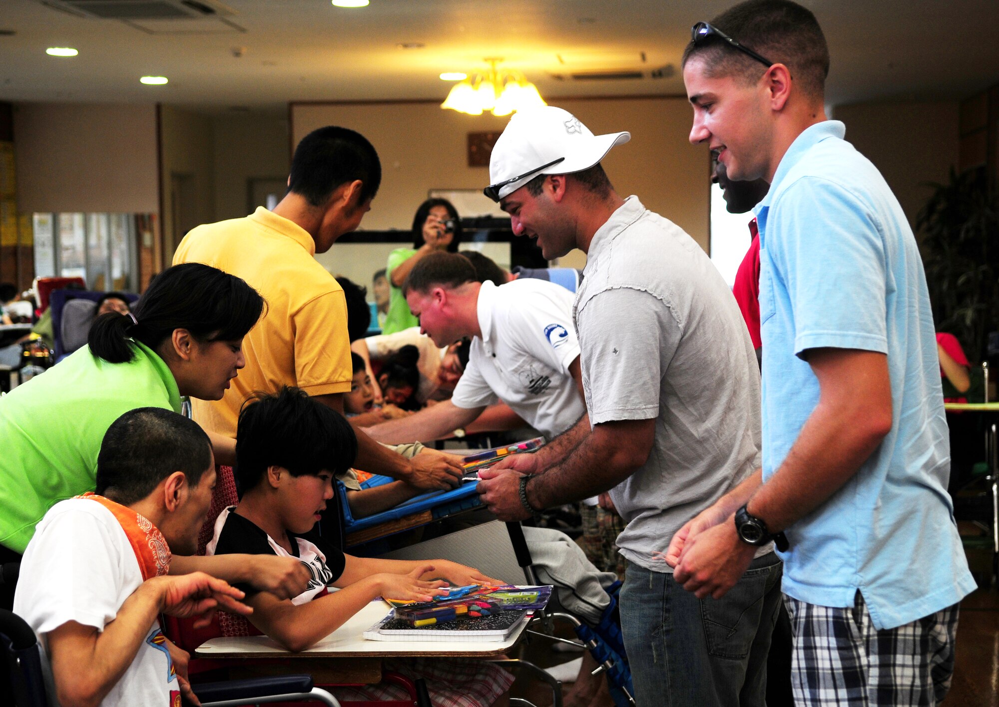 Airmen from the 18th Civil Engineer Squadron Power Pro Shop were given a gift by the children from the Okinawa Children's Development Center, a facility for special needs, August 13. The Airmen delivered school supplies to children which included, notebooks, folders, pencils, color pencils, erasers, rulers, scissors, pencil sharpeners, and pencil cases.  (U.S. Air Force photo/Tech. Sgt. Rey Ramon)     