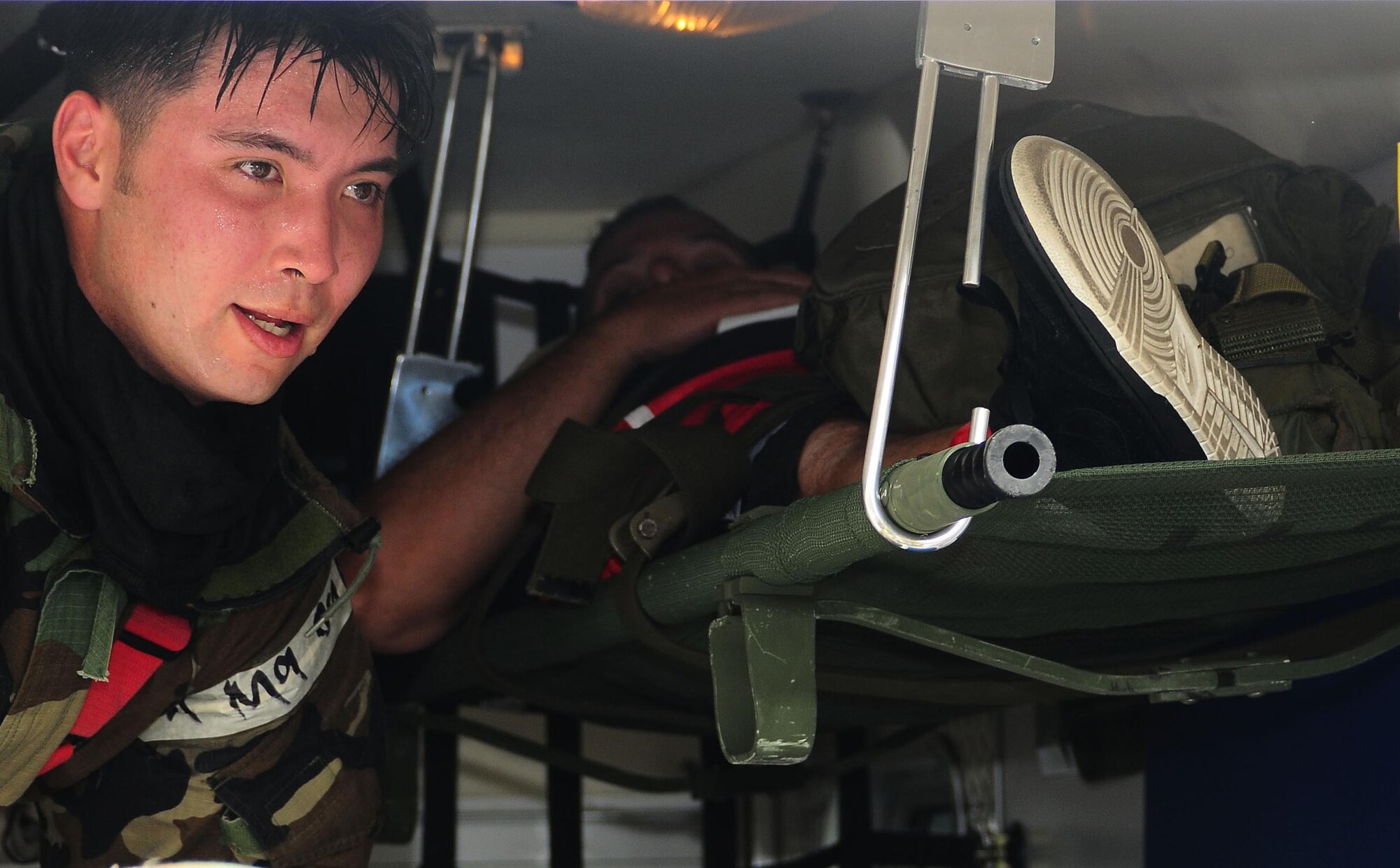 YOKOTA AIR BASE, Japan -- Senior Airmen Alexander Kirchner, 374th Civil Engineer Squadron fire fighter, prepares  a patient for transport following a simulated mortar attack, Aug 13, during Phase II Exercise Beverly Morning 09-06. (U.S. Air Force photo/Airman First Class Devin Doskey)