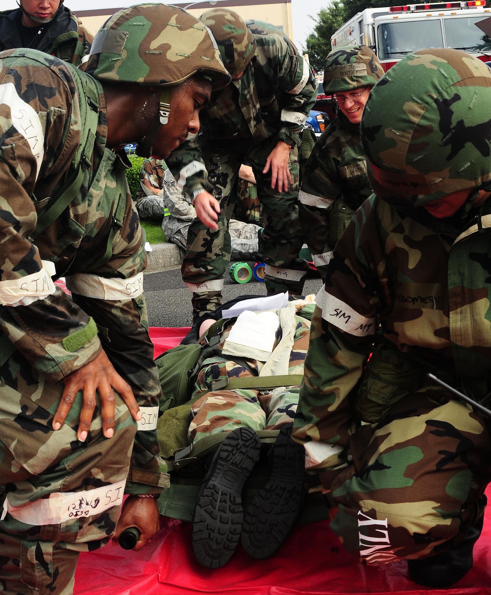 YOKOTA AIR BASE, Japan -- Base fire ans medical personnel prepare a patient for transport following a simulated mortar attack, Aug 13, during Phase II Exercise Beverly Morning 09-06. (U.S. Air Force photo/Airman First Class Devin Doskey)