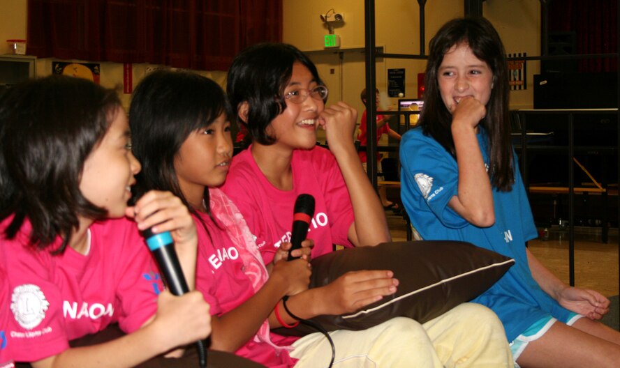 Kiri Yasuda, Ayaka Miyagi, Rina Nagai, and Teri Stewart sing Karaoke during the International Youth Lock-in held at the Kadena Youth Center August 8. The children spent the night playing games, sampling American and Japanese cuisine and making new friends.   (Courtesy photo)  
