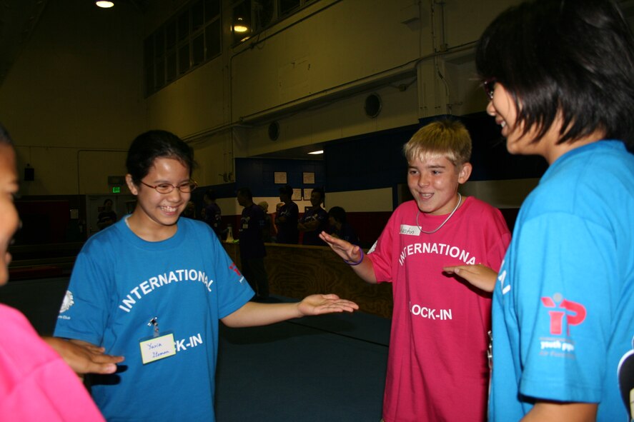 Yuria Itoman (left), Austin Perkins, and Hinata Toguchi play games at the Kadena Youth Center during the International Youth Lock-in August 8. The children spent the night playing games, sampling American and Japanese cuisine and making new friends.   (Courtesy photo)      