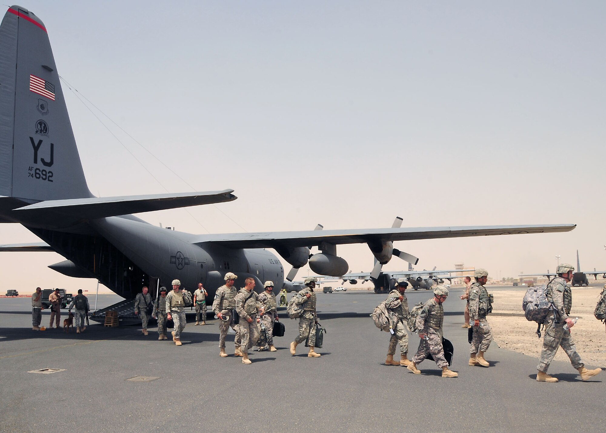SOUTHWEST ASIA -- U.S. Army personnel depart a 737th Expeditionary Airlift Squadron C-130 Hercules on the parking ramp at an undisclosed location in Southwest Asia August 12.  The aircraft is deployed from the 374th Airlift Wing, Yokota Air Base, Japan.  (U.S. Air Force photo/Tech Sgt. Tony Tolley)