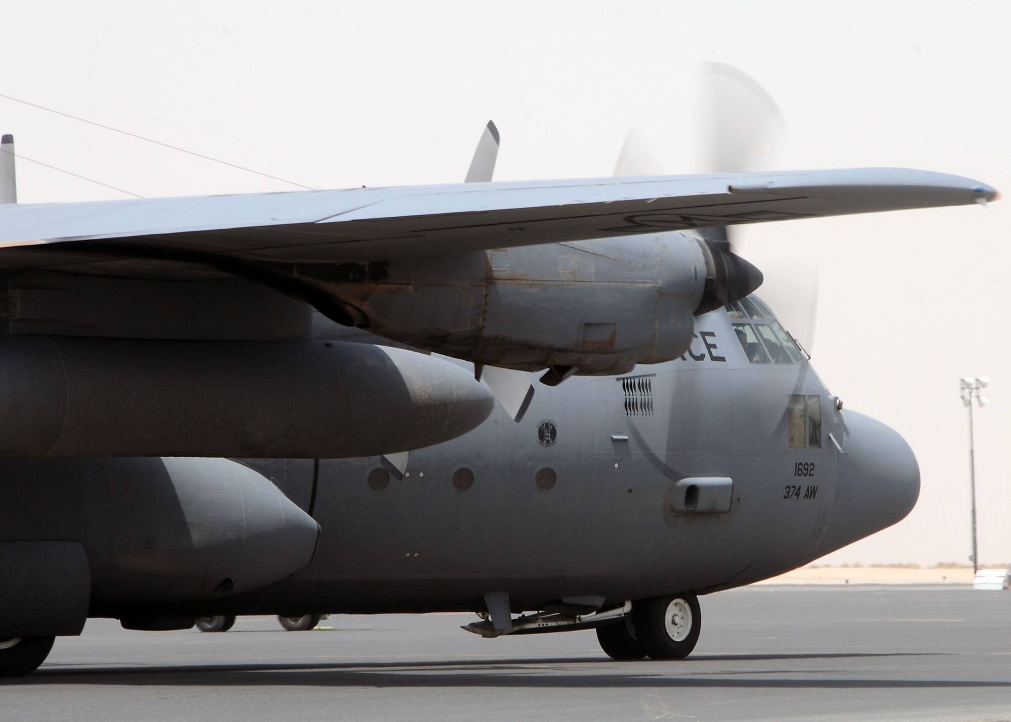 SOUTHWEST ASIA -- A 737th Expeditionary Airlift Squadron C-130 Hercules taxis into position at the uniform parking ramp at an undisclosed location in Southwest Asia August 12.  The aircraft is deployed from the 374th Airlift Wing, Yokota Air Base, Japan.  (U.S. Air Force photo/Tech Sgt. Tony Tolley)
