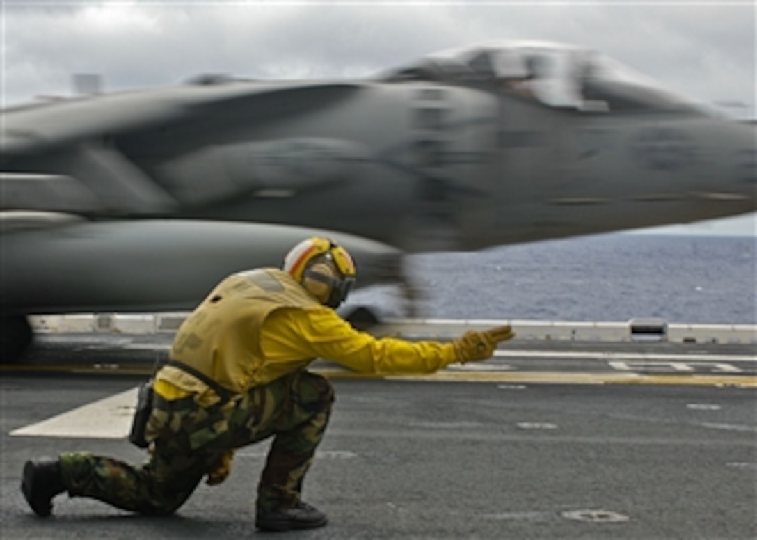 U.S. Navy Petty Officer 1st Class Michael Quintos launches an AV-8B Harrier aircraft during the fly off of Marine Attack Squadron 211, 31st Marine Expeditionary Unit from the flight deck of the amphibious assault ship USS Essex (LHD 2) in the Philippine Sea on Aug. 10, 2009.  