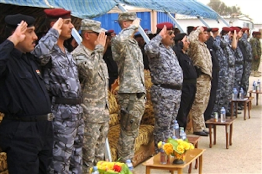 U.S. Army leaders and Iraqi police salute during the playing of Mawtini, the Iraqi national
anthem, during a ceremony for 875 Iraqi police graduates in Maysan province, Iraq, July 30, 2009. The U.S. soldiers, assigned to the 304th Battalion, 6th Infantry Regiment, advise and assist Iraqi police in the province.