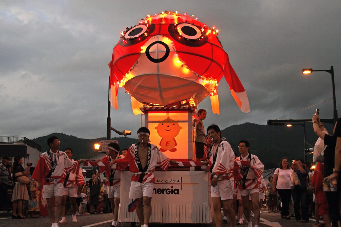 Parade particpants chant and blow whistles as they pull a goldfish float down the street at the annual Goldfish Lantern Festival in Yanai Aug.13. Yanai locals made the float by hand. Most of the floats featured lights and musical performers. According to the Yanai City Official Web site, nearly 150 years ago Yanai merchants began making goldfish lanterns for their children. The children played with the lanterns in the streets, thus beginning the festival.