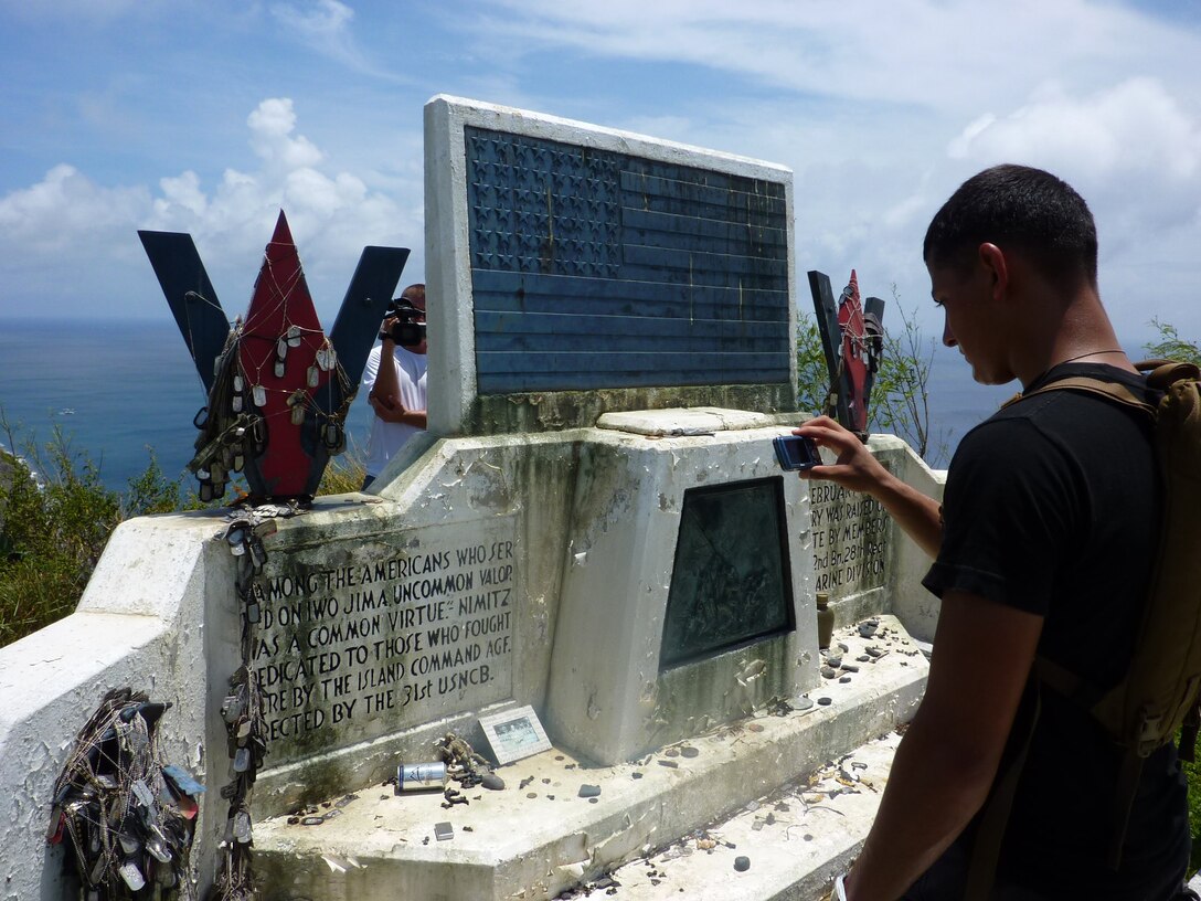 An Iwakuni-based Marine photographs a memorial constructed on Iwo To, formerly known as Iwo Jima, Aug 13 during their island hop trip. Iwakuni Marines embarked on an 11-day expedition Aug. 3 to various locations across the Pacific to commemorate the Marine Corps 67th anniversary of World War II’s Guadalcanal Campaign.