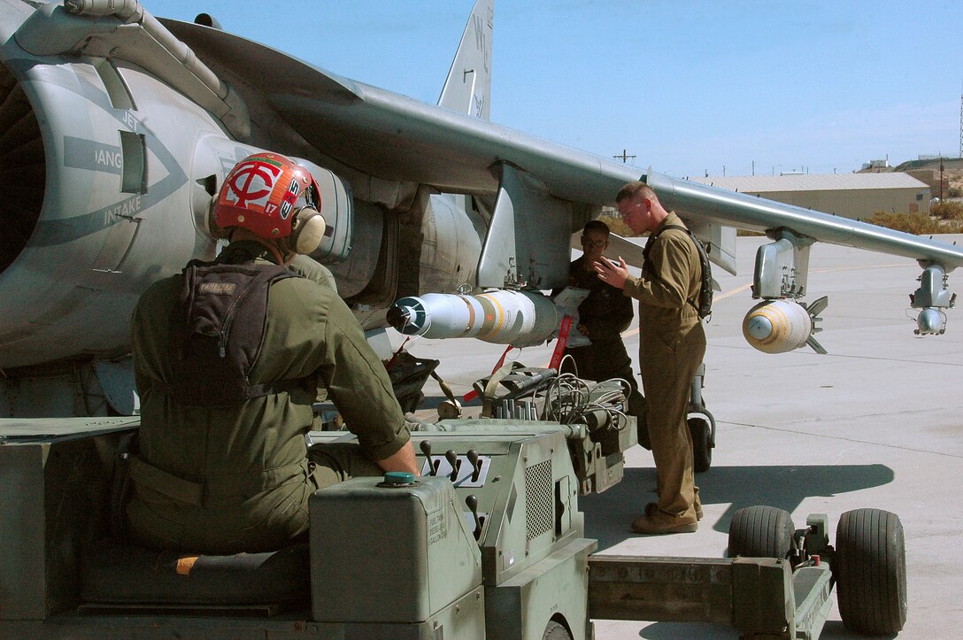Cpl. Terryl Carrier, left, Lance Cpl. Erin Donahue and Sgt. Justin Buschbacher, Marine Attack Squadron 311 ordnance technicians, remove a 500-pound GBU-12 laser-guided bomb from an AV-8B Harrier on the flight line at the Marine Corps Air Station in Yuma, Ariz., Aug. 13, 2009. The squadron dropped approximately 30 tons of ordnance at the station’s ranges Aug. 10-13, which is several times more than the squadron typically uses in a week. Marine Aircraft Group 13’s four Harrier squadrons compete every year to see who can accurately drop the most ordnance over the course of an event dubbed "MAG War." However, since every other squadron just returned from deployment, is deployed or preparing to deploy, VMA-311 was the only squadron to participate this year.
