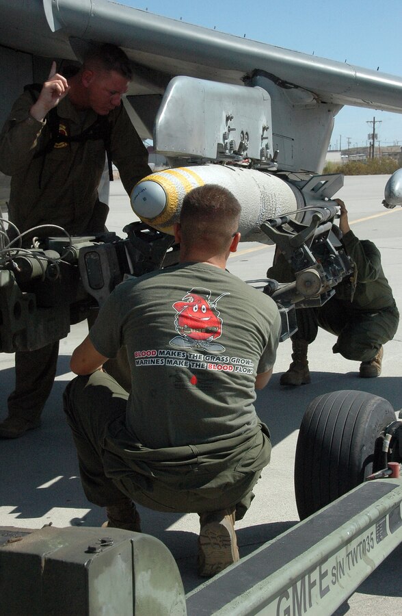 Sgt. Justin Buschbacher, left, Lance Cpl. Jose Rodriguez and Lance Cpl. Erin Donahue, Marine Attack Squadron 311 ordnance technicians, remove a 500-pound MK-82 general purpose bomb from an AV-8B Harrier on the flight line at the Marine Corps Air Station in Yuma, Ariz., Aug. 13, 2009. The squadron dropped approximately 30 tons of ordnance at the station’s ranges Aug. 10-13, which is several times more than the squadron typically uses in a week. Marine Aircraft Group 13’s four Harrier squadrons compete every year to see who can accurately drop the most ordnance over the course of an event dubbed "MAG War." However, since every other squadron just returned from deployment, is deployed or preparing to deploy, VMA-311 was the only squadron to participate this year.