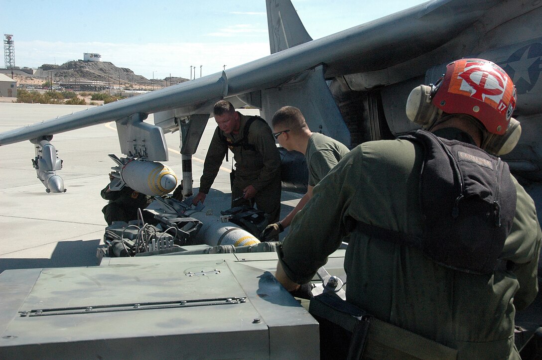 Marine Attack Squadron 311 ordnance technicians remove a 500-pound MK-82 general purpose bomb from an AV-8B Harrier on the flight line at the Marine Corps Air Station in Yuma, Ariz., Aug. 13, 2009. The squadron dropped approximately 30 tons of ordnance at the station’s ranges Aug. 10-13, which is several times more than the squadron typically uses in a week. Marine Aircraft Group 13’s four Harrier squadrons compete every year to see who can accurately drop the most ordnance over the course of an event dubbed "MAG War." However, since every other squadron just returned from deployment, is deployed or preparing to deploy, VMA-311 was the only squadron to participate this year.