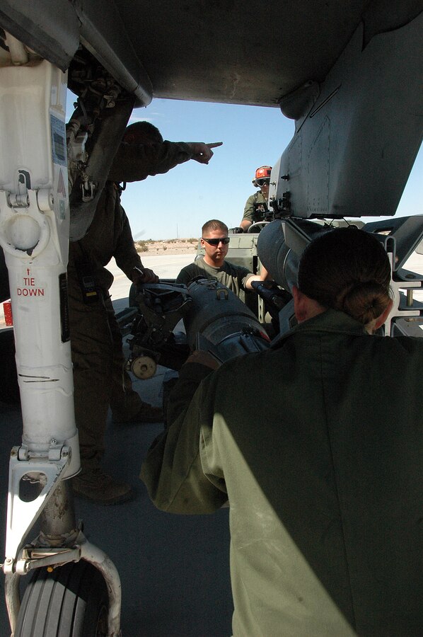 Marine Attack Squadron 311 ordnance technicians remove a 500-pound MK-82 general purpose bomb from an AV-8B Harrier on the flight line at the Marine Corps Air Station in Yuma, Ariz., Aug. 13, 2009. The squadron dropped approximately 30 tons of ordnance at the station’s ranges Aug. 10-13, which is several times more than the squadron typically uses in a week. Marine Aircraft Group 13’s four Harrier squadrons compete every year to see who can accurately drop the most ordnance over the course of an event dubbed "MAG War." However, since every other squadron just returned from deployment, is deployed or preparing to deploy, VMA-311 was the only squadron to participate this year.