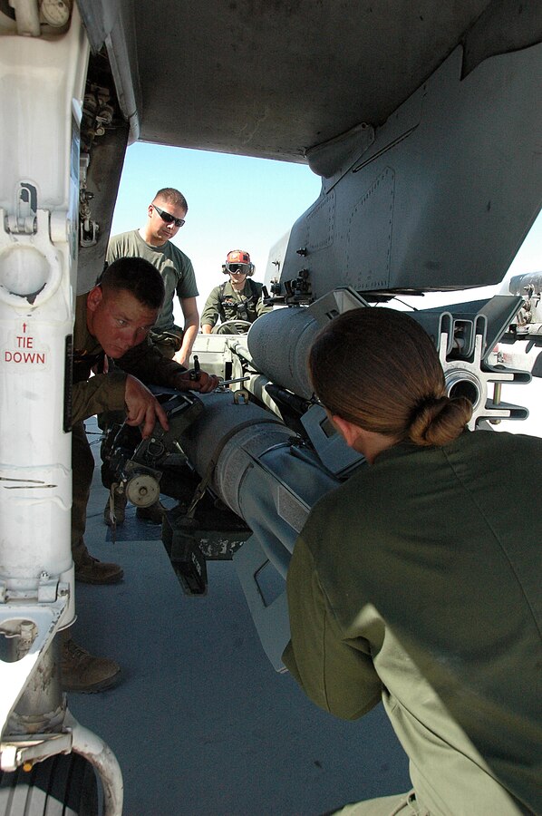 Marine Attack Squadron 311 ordnance technicians remove a 500-pound MK-82 general purpose bomb from an AV-8B Harrier on the flight line at the Marine Corps Air Station in Yuma, Ariz., Aug. 13, 2009. The squadron dropped approximately 30 tons of ordnance at the station’s ranges Aug. 10-13, which is several times more than the squadron typically uses in a week. Marine Aircraft Group 13’s four Harrier squadrons compete every year to see who can accurately drop the most ordnance over the course of an event dubbed "MAG War." However, since every other squadron just returned from deployment, is deployed or preparing to deploy, VMA-311 was the only squadron to participate this year.