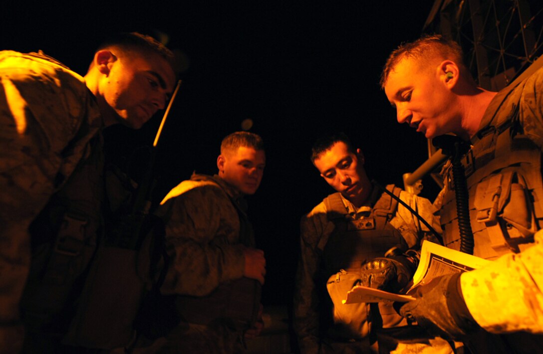 First Lt. Christopher Ferguson (right), from Bakersfield, Calif., and other Marines from Weapons Company, Battalion Landing Team 2/4, review their assault plan aboard an air-cushioned landing craft prior to conducting a raid on San Clemente Island Aug. 12. Marines and sailors with the 11th Marine Expeditionary Unit, embarked on amphibious assault ships off the coast of California, are conducting a wide array of military operations during their certification exercise scheduled to end Aug. 21. The raid, conducted by Marines with Weapons Company, Battalion Landing Team 2/4, was the first ship-to-shore assault that the MEU conducted during the exercise. Ferguson is the Light Armored Reconnaissance Platoon commander, Weapons Company, BLT 2/4.
