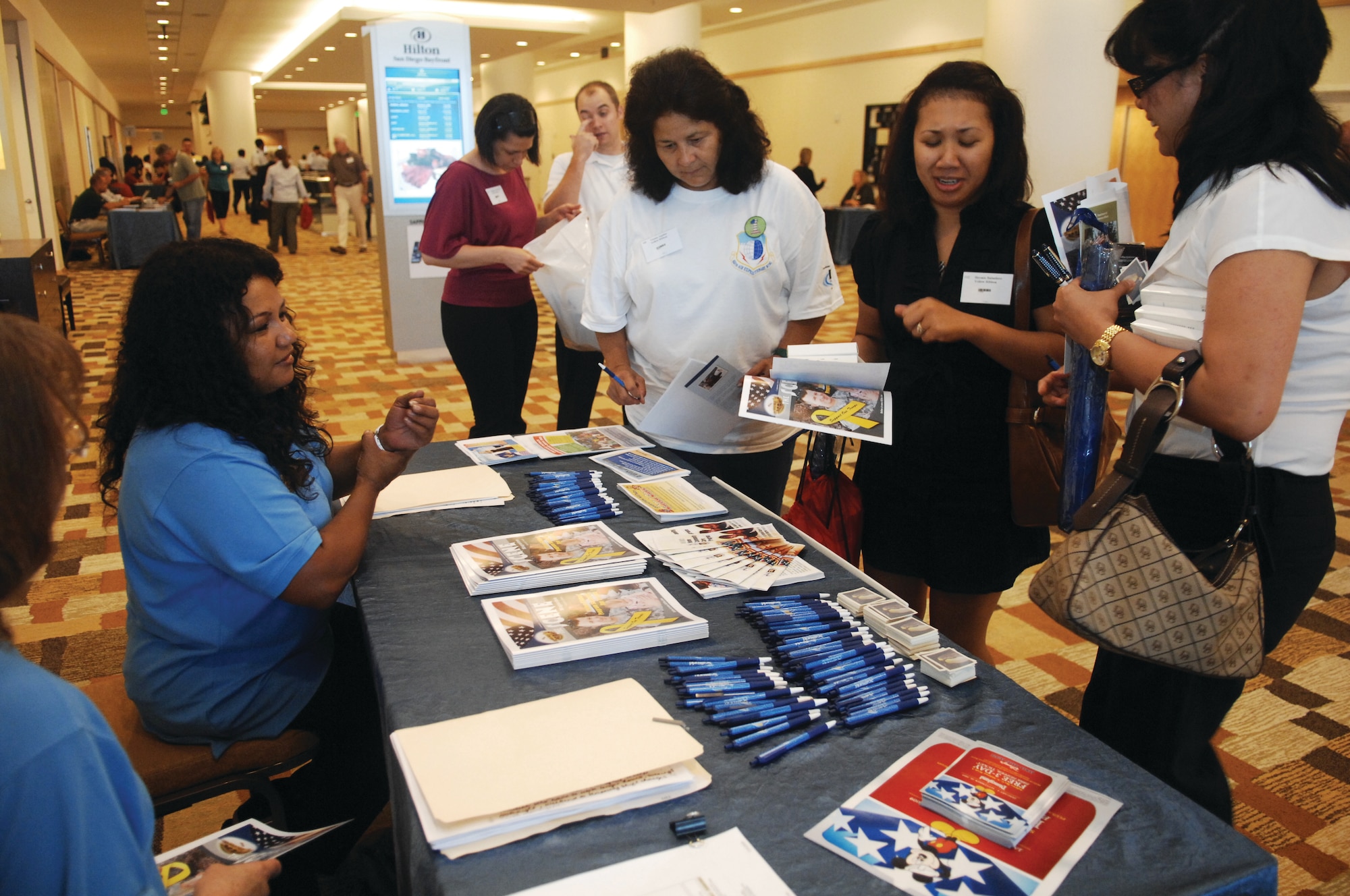 Service members and their families collect information at the 452nd Force Support Squadron booth at the Yellow Ribbon Reintegration Program held in the Hilton San Diego Bayfront hotel last weekend. Booth visitors learned about free child care during UTA weekends, complimentary tickets to SeaWorld and Disneyland and other R&R activities that the unit offers. About a dozen vendors briefed attendees on veterans’ benefits, TRICARE, The Soldiers Project, Military OneSource, Military and Family Life Consultant Program and Army Reserve Family Programs. (U.S. Air Force Photo by Tech. Sgt. Carolyn Erfe)