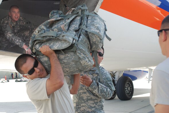 ONE LAST DUTY: Soldiers from the California National Guard’s 1st Battalion, 185th Armored Regiment unload rucksacks from the chartered aircraft that transported their unit to March ARB Tuesday, August 11. The Soldiers were part of the second wave of more than 800 Soldiers from the California National Guard returning from a yearlong deployment in Iraq. Over 300 of the Soldiers were from the Los Angeles, San Bernardino, and San Diego areas and returned via two flights on August 6 and the third flight on August 11.   During their deployment, the Soldiers conducted more than 2,000 combat logistics patrols and provided more than 1.7 million miles of convoy security in Iraq. The Battalion came in contact with small arms fire and improvised explosive devices (IEDs) on several occasions, but did not sustain any life-threatening injuries. The Soldiers were augmenting the 81st Heavy Brigade Combat Team, based in Seattle.  (U.S. Air Force Photo by Megan Just)