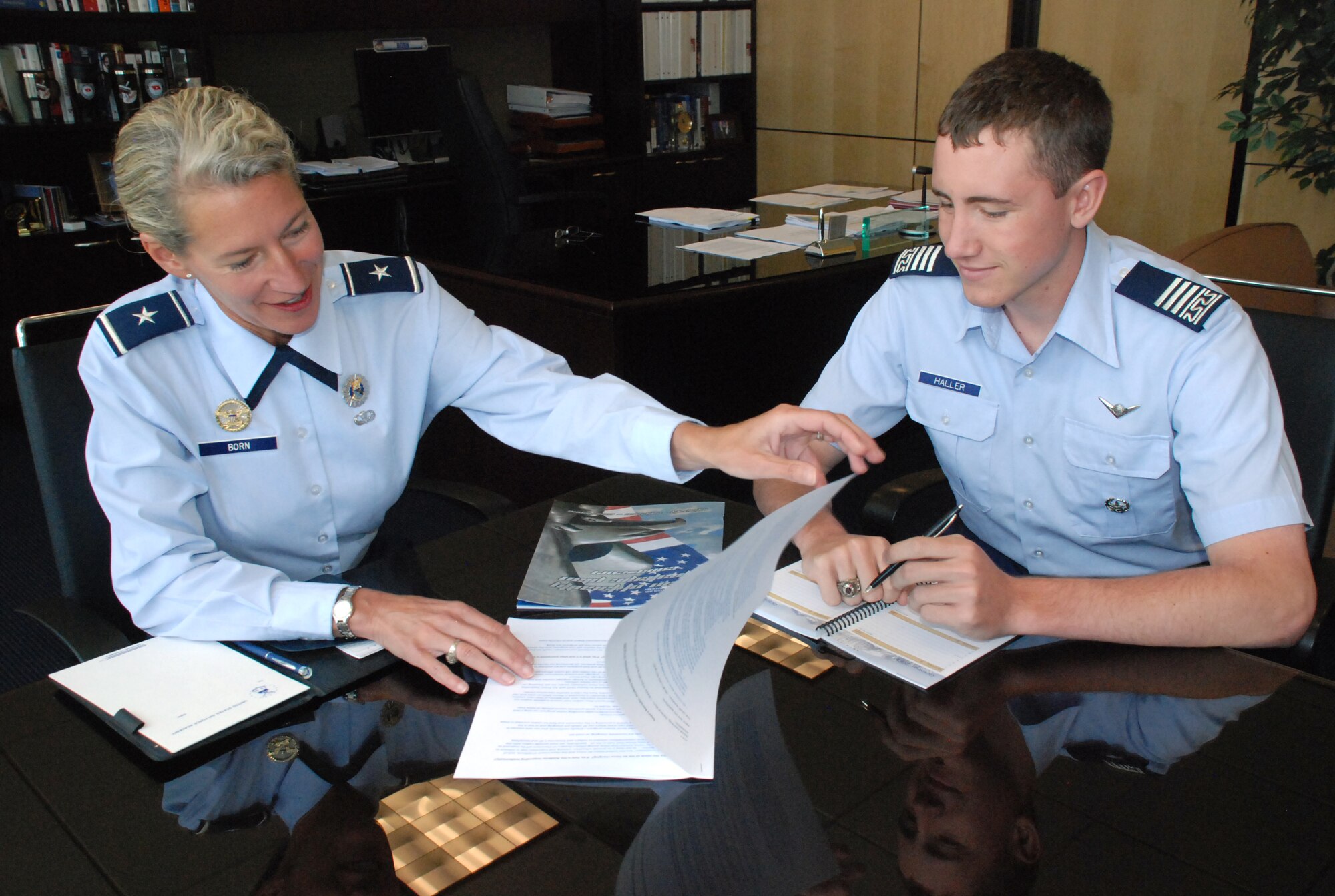 Brig. Gen. Dana Born and Cadet 1st Class Charles Haller take a look at academic activities planned for the Fall 2009 semester at the U.S. Air Force Academy in Colorado Springs, Colo., Aug. 8. Student academic support services and the unmanned aerial systems program are slated to expand this year. General Born is dean of the faculty. Cadet Haller is the Cadet Wing director of academics. (U.S. Air Force photo/Ann Patton)