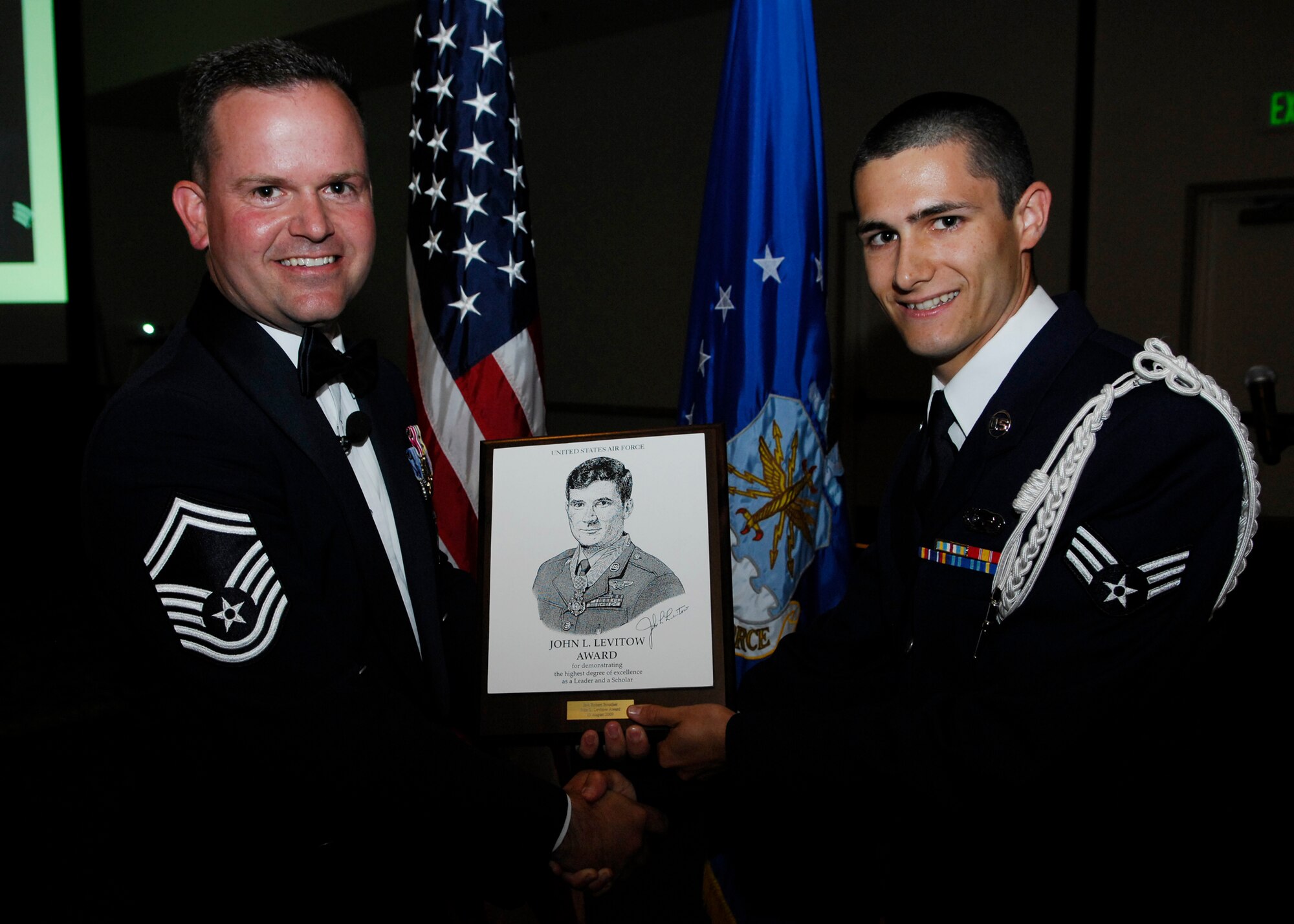 VANDENBERG AIR FORCE BASE, Calif. -- For his exemplary efforts during Airman Leadership School, Senior Airman Robert Boucher of the 18th Intelligence Squadron is awarded the John L. Levitow award by guest speaker Senior Master Sgt. Robert Bedell during graduation of Class 2009-Foxtrot here Aug. 13. The John L. Levitow award is presented to the student who demonstrates the most outstanding leadership qualities during the five week class. (U.S. Air Force photo/Airman 1st Class Heather R. Shaw)