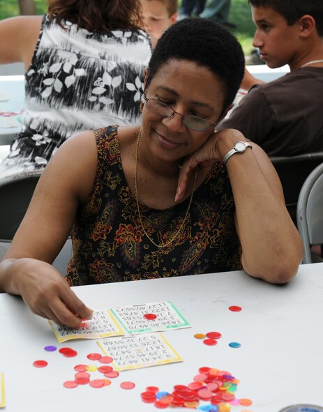 Senior Master Sgt. Janet Hawkins, 512th Maintenance Operations Flight, plays a round of bingo at the 512th Airlift Wing bi-annual picnic Aug. 1 at the Eagle's Nest picnic area on Dover Air Force Base. More than 1,200 reservists and their families attended the event. (U.S. Air Force photo/Capt. Marnee A.C. Losurdo)