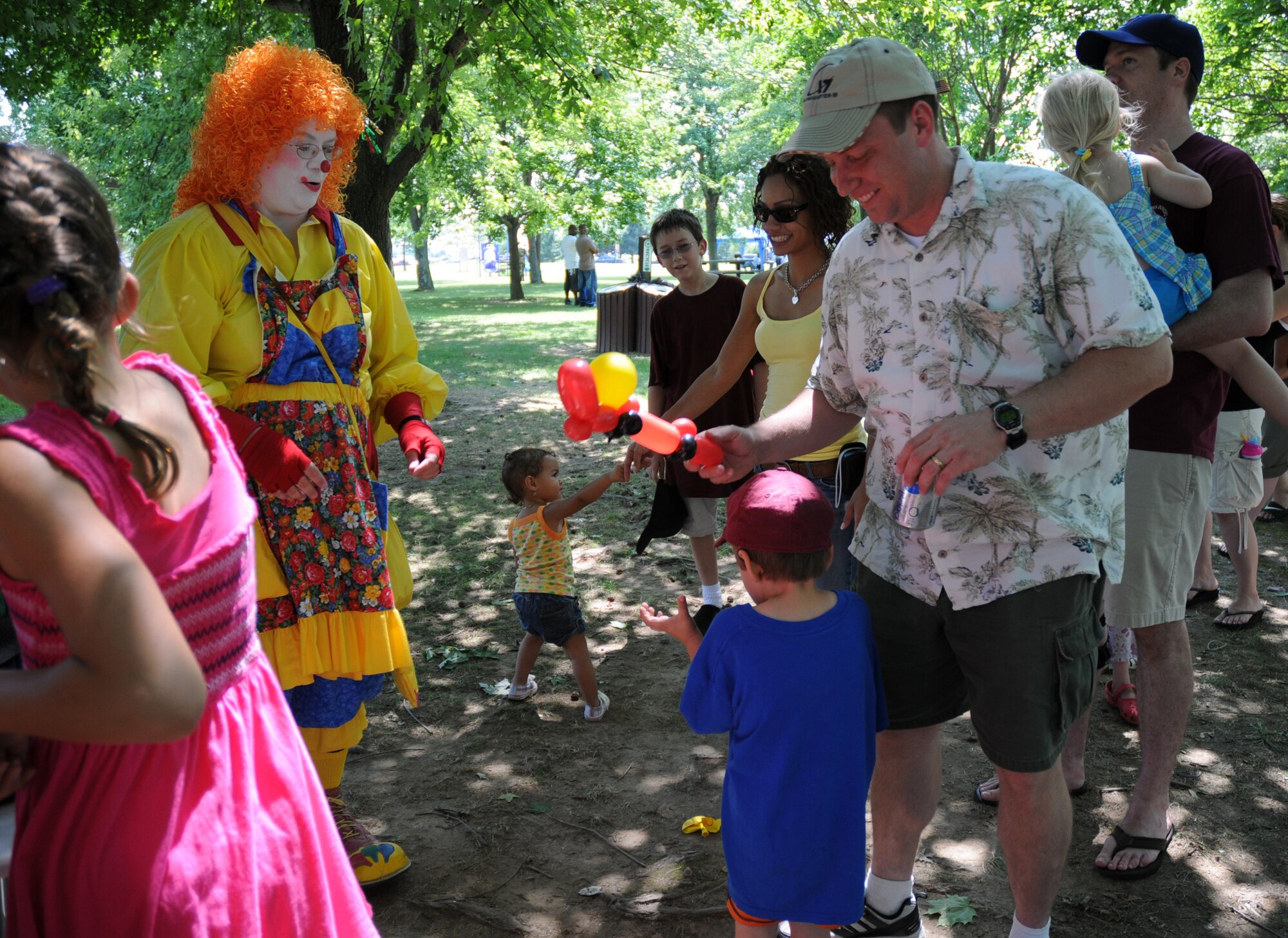 Snippy Doodles the clown makes a car out of balloons for Alex Kaehler, 4, at the 512th Airlift Wing bi-annual picnic Aug. 1 held at the Eagle's Nest Picnic Area.  Alex is the son of Master Sgt. Robert Kaehler, a loadmaster with the Air Force Reserve's 326th Airlift Squadron. (U.S. Air Force photo/Capt. Marnee A.C. Losurdo) 