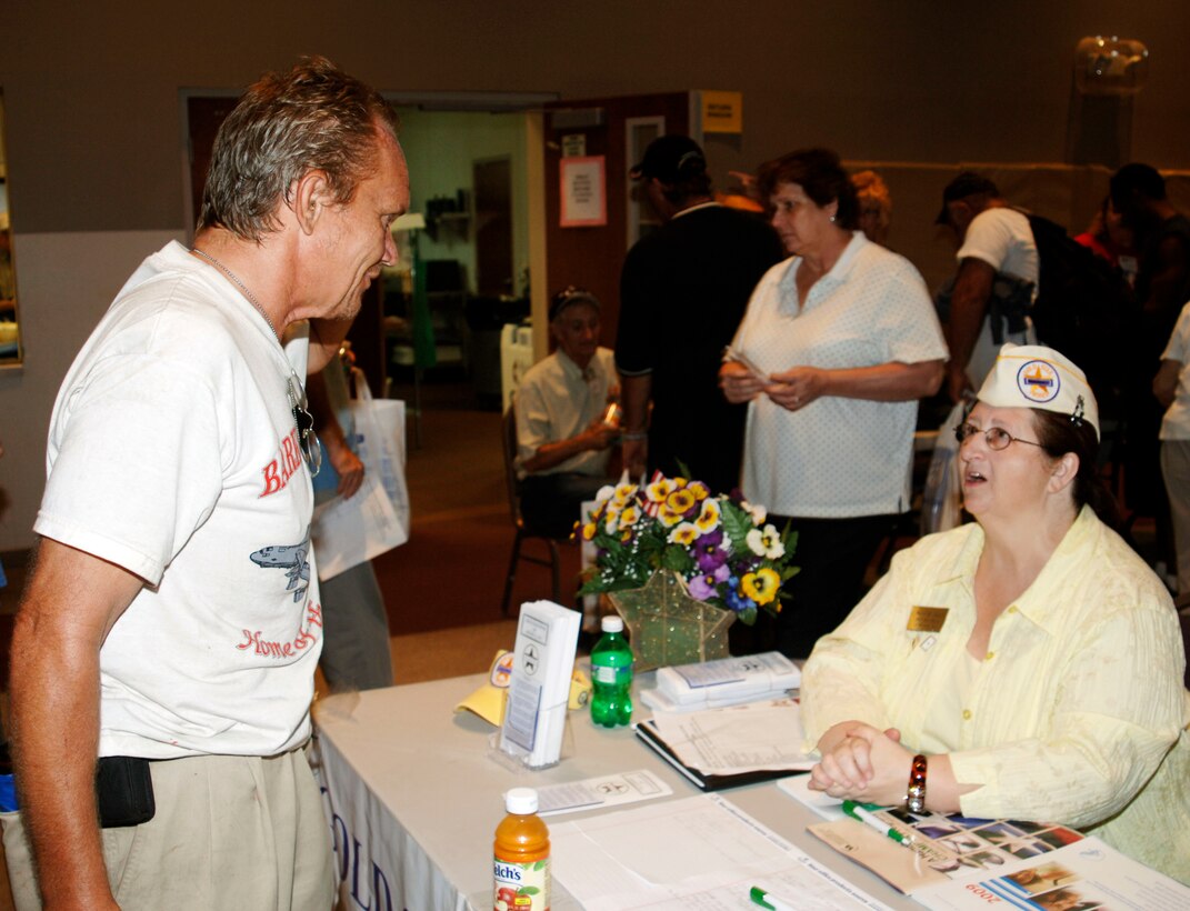 Ms. Marie Cain, Suncoast Chapter President of "Gold Star Wives of America, Inc." speaks to a homeless veteran at the annual "Standown" event (U.S. Air Force Photo/Capt. Shane O. Huff)