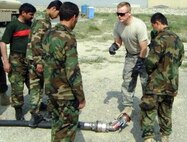 Master Sgt. Tracy Wolfe teaches his students about the single point nozzle Aug. 6 in Kabul, Afghanistan. He taught subjects including information safety, vehicle inspection, facility inspection, forms and fueling operations through two blocks of instruction over a 33-day period. Sergeant Wolfe instructed Kabul's first Petroleum, Oils and Lubricants course. Sergeant Wolfe is a fuels complex instructor assigned to the 364th Training Squadron fuels complex instructor. (U.S. Air Force photo) 