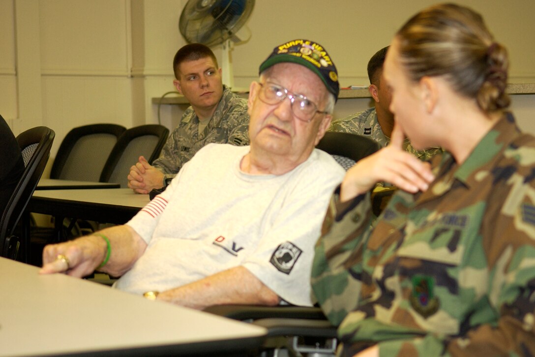 GRISSOM AIR RESERVE BASE, Ind., -- Senior Airman Anna Jones, 434th ARW chaplain's office, speaks with, Charles Ferguson, World War II veteran and Purple Heart recipient, during a special luncheon held at the Airman and Family Readiness Center recently. The luncheon sponsored by the center and the Seasoning Training Flight, allowed local veterans and Airman an opportunity to interact with each other. (U.S. Air Force photo/Tech. Sgt. Doug Hays)