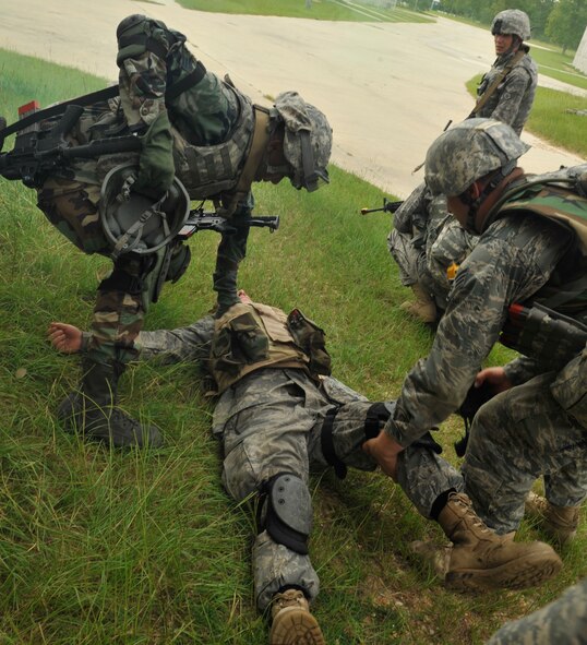 CAMP BLANDING, Fla. -- Battlefield weather Airmen transport a simulated casualty during military operations in urban terrain village training here July 29. Members from the 93rd Air Ground Operations Wing, a tenant wing at Moody Air Force Base, Ga., were students at the Cyclogenesis course and were sent to the training to learn the U.S. Army's basic warrior tasks, which include qualifying on certain weapon systems, small unit tactics and MOUT village training. (U.S. Air Force photo by Senior Airman Schelli Jones)