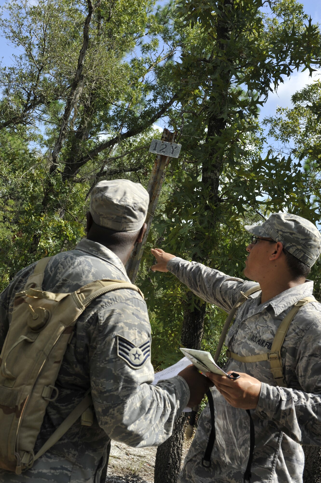 CAMP BLANDING, Fla. -- Staff Sgt. Corey Robinson and Senior Airman James Pomar, both members of the 93rd Air Ground Operations Wing, a tenant wing at Moody Air Force Base, Ga., find their first check point during a land navigation exercise in the Cyclogenesis course held here July 28. Students were required to find three check points in three hours. (U.S. Air Force photo by Senior Airman Schelli Jones)