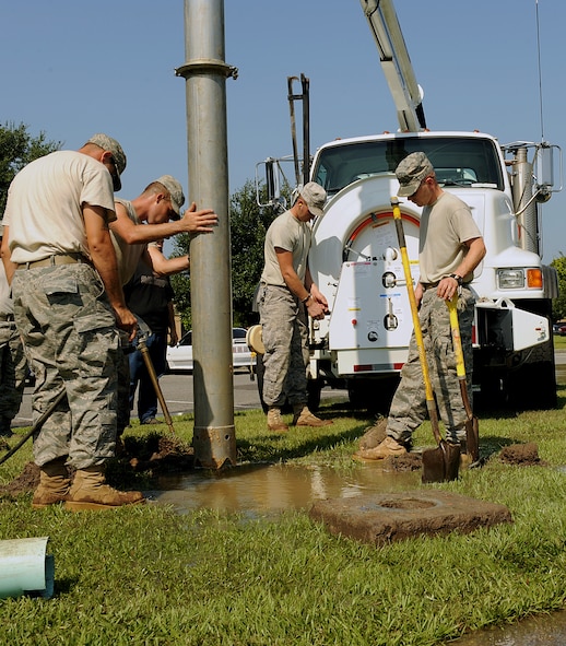 MOODY AIR FORCE BASE, Ga. -- Airmen from the 23rd Civil Engineer Squadron repair a main water line leak here Aug. 11. The Airmen used Vac-Con equipment to remove the excess water from the hole in order to gain access to the broken line. (U.S. Air Force photo by Airman 1st Class Joshua Green)