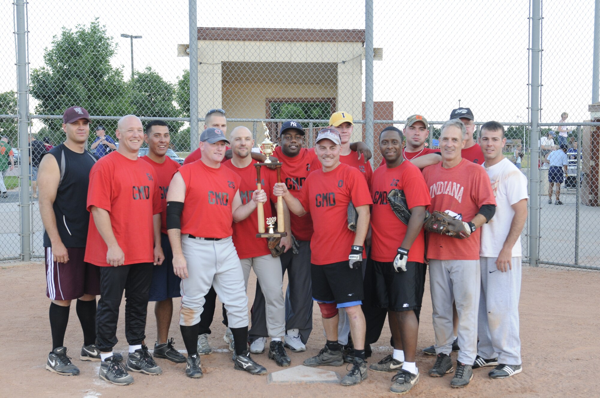 The 100th Missile Defense Brigade (Ground-based Midcourse Defense) softball team poses at home plate after winning the Peterson Air Force Base silver intramural softball league championship Aug. 11. (Army photo by Sgt. Michael Cost)
