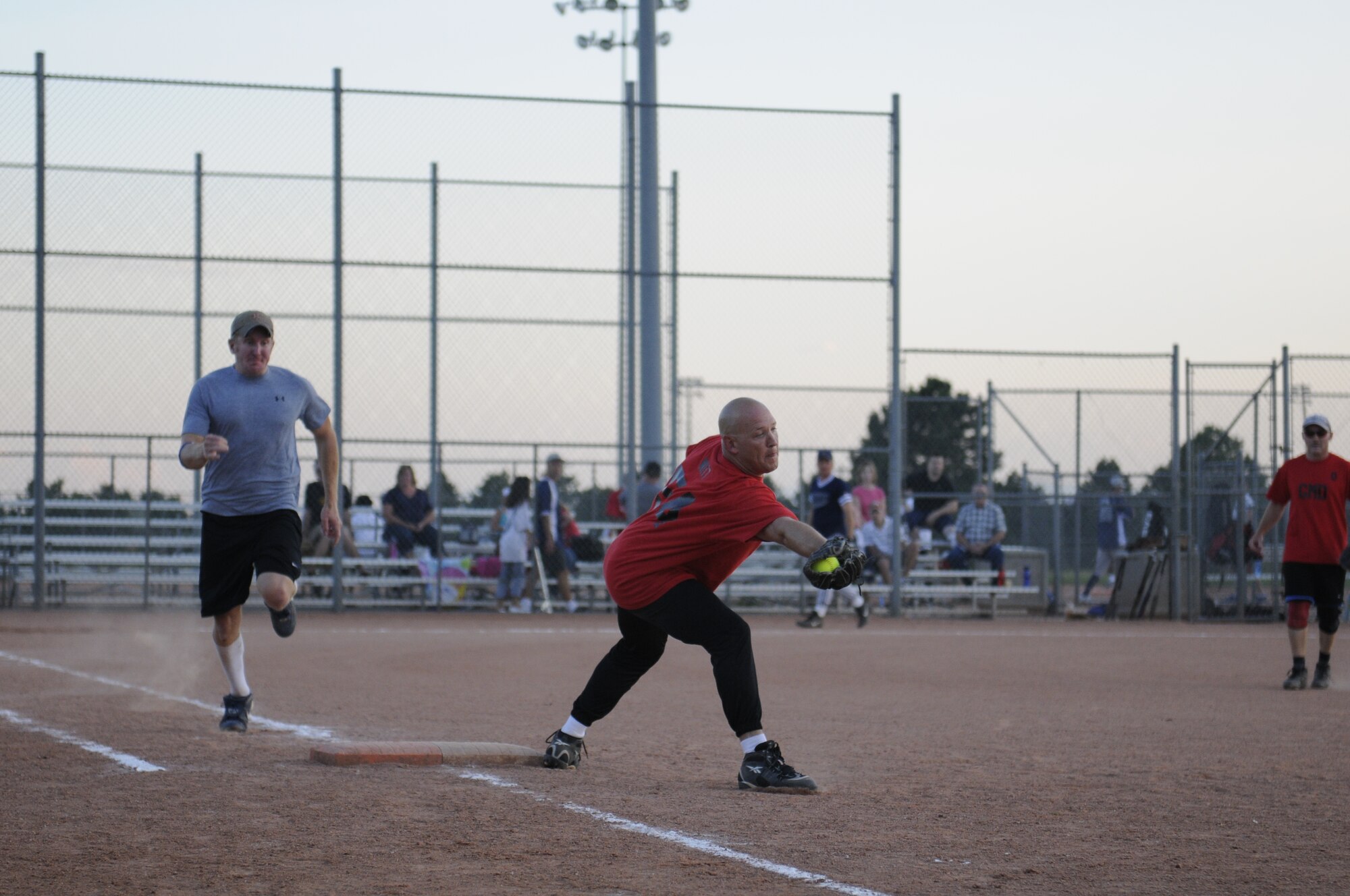 Maj. Chad Witt, Current Operations Officer, 100th Missile Defense Brigade (Ground-based Midcourse Defense), extends to catch a “throw-out” at first base which was one of the outs during the final inning of the Peterson Air Force Base silver intramural softball league championship game Aug. 11. This out was one of three that inning that culminated the 100th MDB team’s undefeated season and championship game victory. (Army photo by Sgt. Michael Cost)