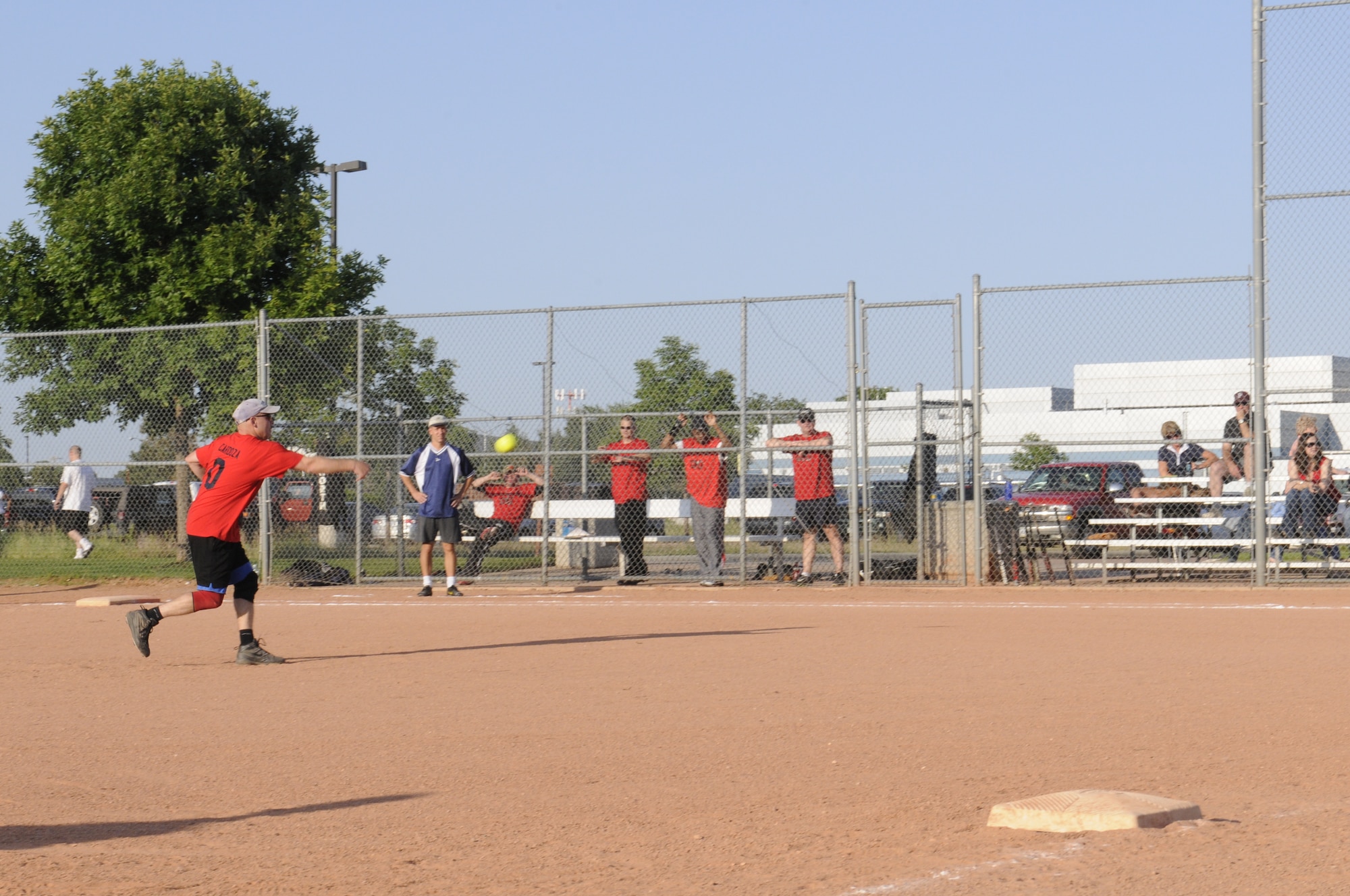 Master Sgt. Daniel Cardoza, Senior Supply noncommissioned officer, pitcher and coach, 100th Missile Defense Brigade (Ground-based Midcourse Defense), throws the opening pitch in the Peterson silver intramural softball league championship game Aug. 11. (Army photo by Sgt. Michael Cost)