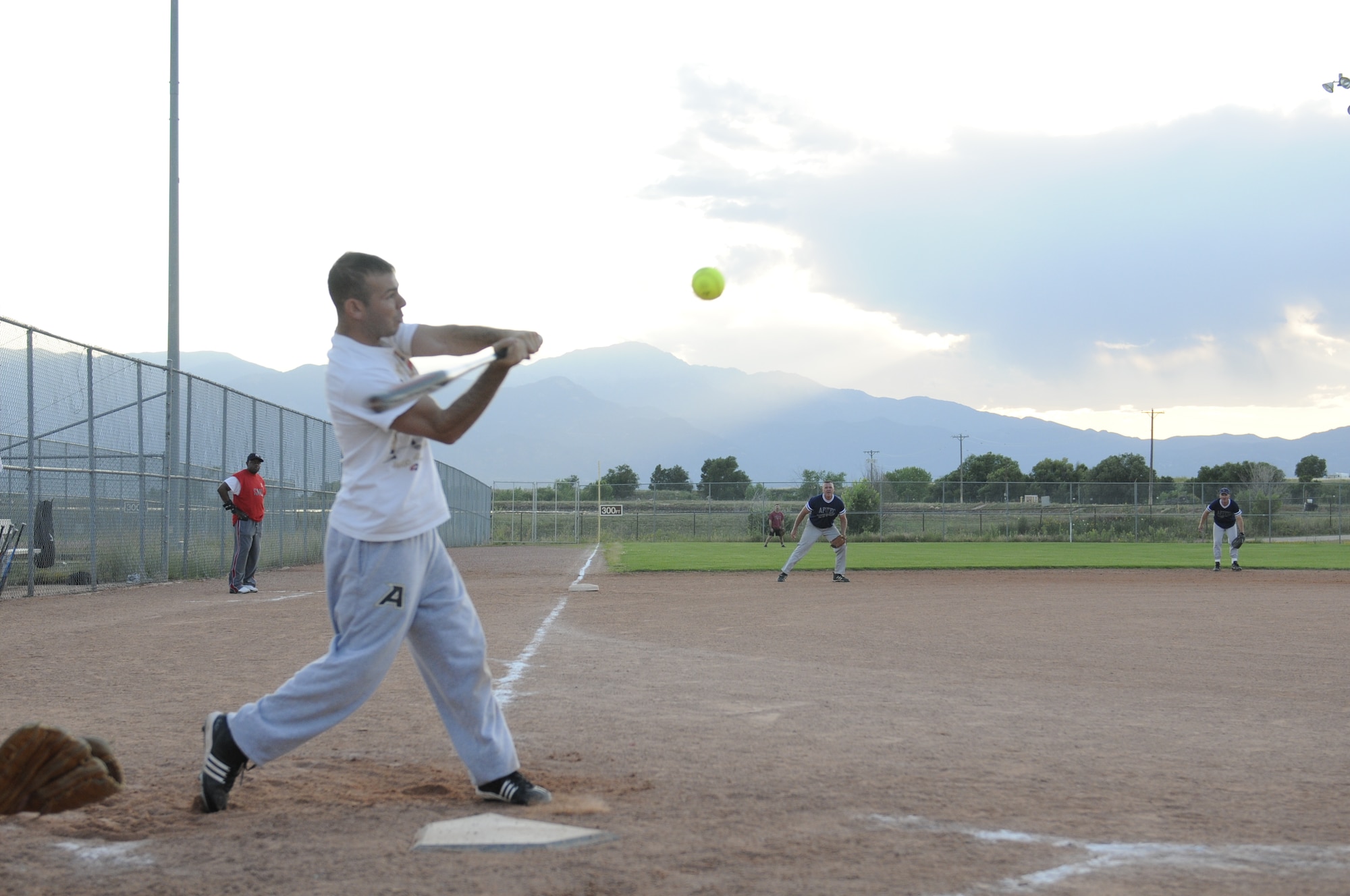 1st Lt. Michael Tatz, Current Operations Officer, 100th Missile Defense Brigade (Ground-based Midcourse Defense), swings at a pitch that will end up getting him on base and advancing runners already on during the Peterson silver intramural softball league championship game Aug. 11. (Army photo by Sgt. Michael Cost)