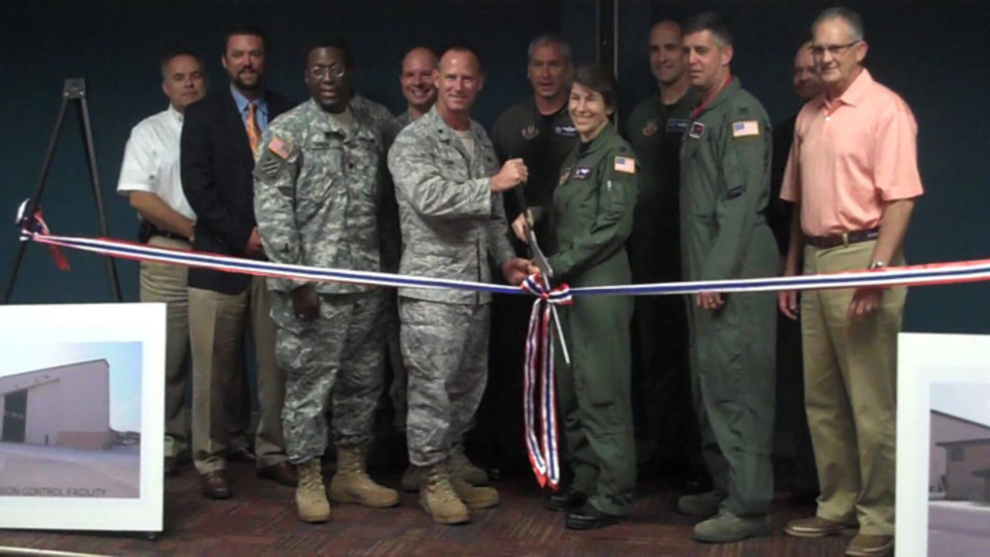 SEYMOUR JOHNSON AIR FORCE BASE, N.C. --  Col. Caroline Evernham, 916th Operations Group commander, and Lt. Col. Charles Combs, 916th Maintenance Group commander, lead the contingency of of military and community leaders present to cut the ribbon on the new corrosion control hangar and squadron operations building. The ceremony was held on Aug 14 here to dedicate the $26 million project. (U.S. Air Force photo by Maj. Shannon Mann/916ARW PA)