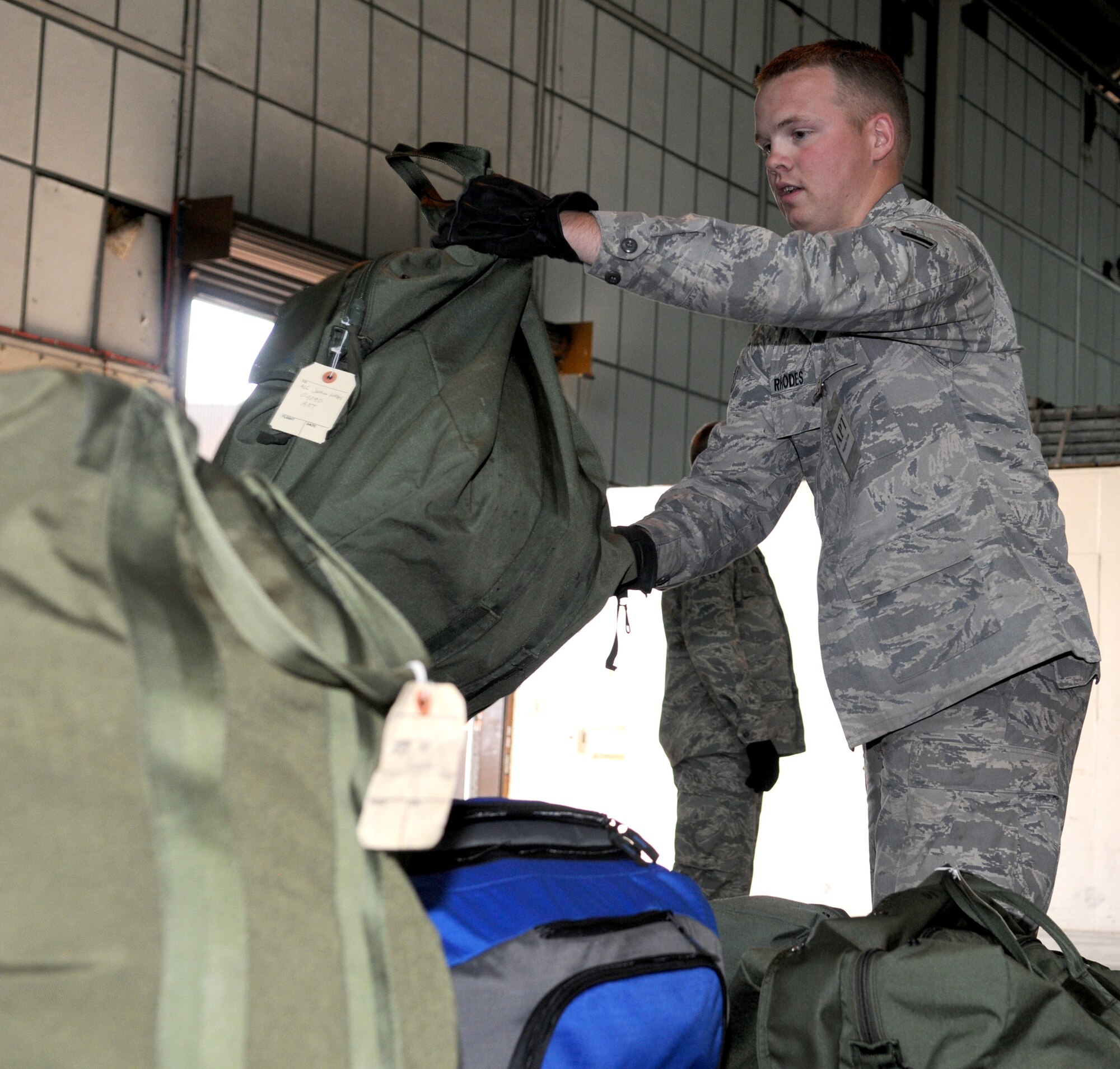 RAF MILDENHALL, England – Senior Airman Brandon Rhodes, 100th Logistics Readiness Squadron, stacks bags to prepare a pallet for a deployment at Building 550 during the Phase I portion of the exercise Aug. 13. Airmen practice for possible real world deployment scenarios to ensure a smooth transition. (U.S. Air Force photo by Staff Sgt. Jerry Fleshman)