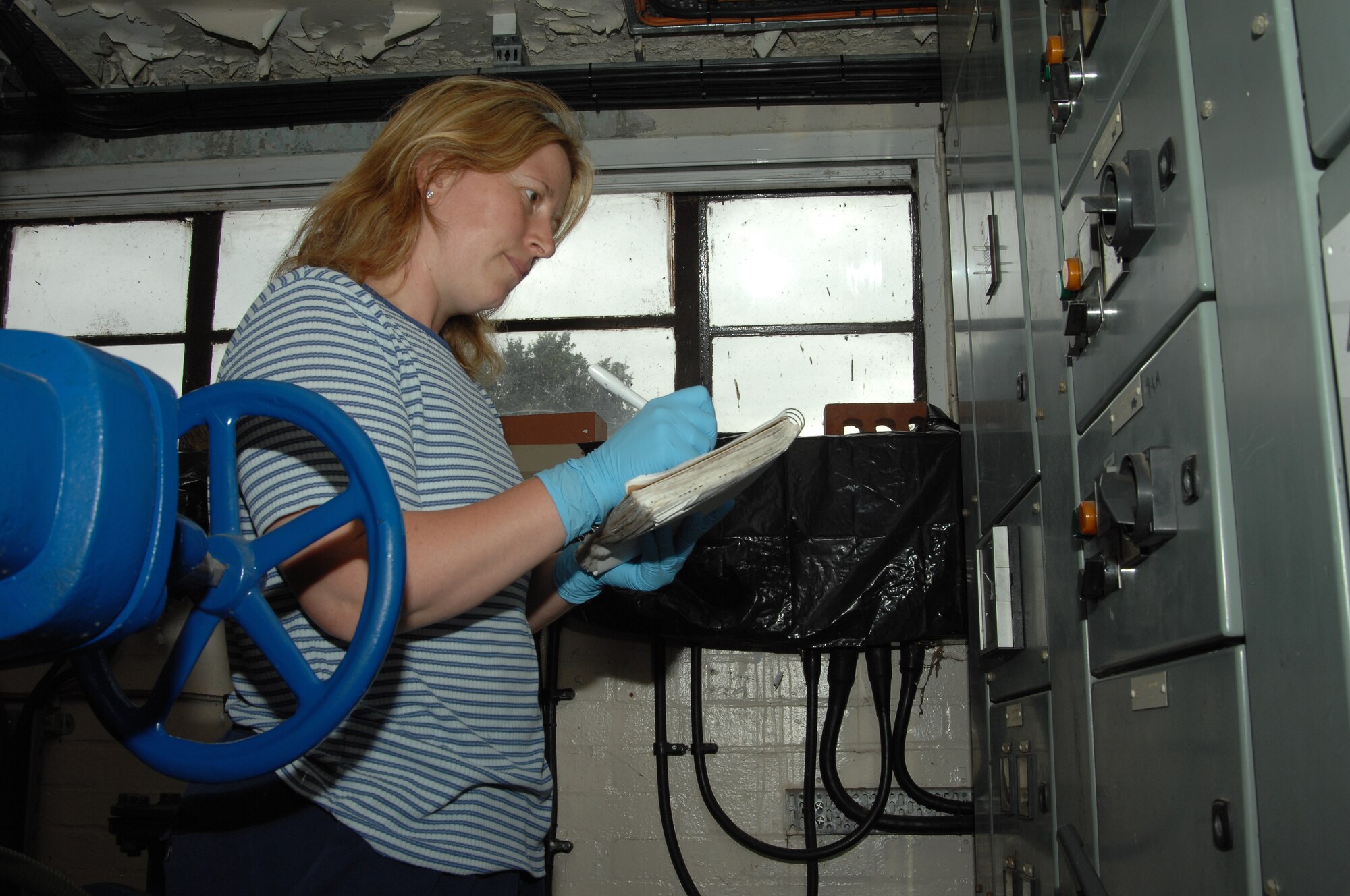 Emma Bailey-Willis, 48th Civil Engineer Squadron Waste and Water Treatment operator, writes down readings from waste pumps, August 6, 2009, at RAF Lakenheath, England. The readings are taken to make sure the pumps are running properly and being changed over on a day-to-day basis. The waste and water plant cleans the water by passing it through several treatment and filtration processes before reintroducing it into the environment. (U.S. Air Force photo/Cassie Coleman)