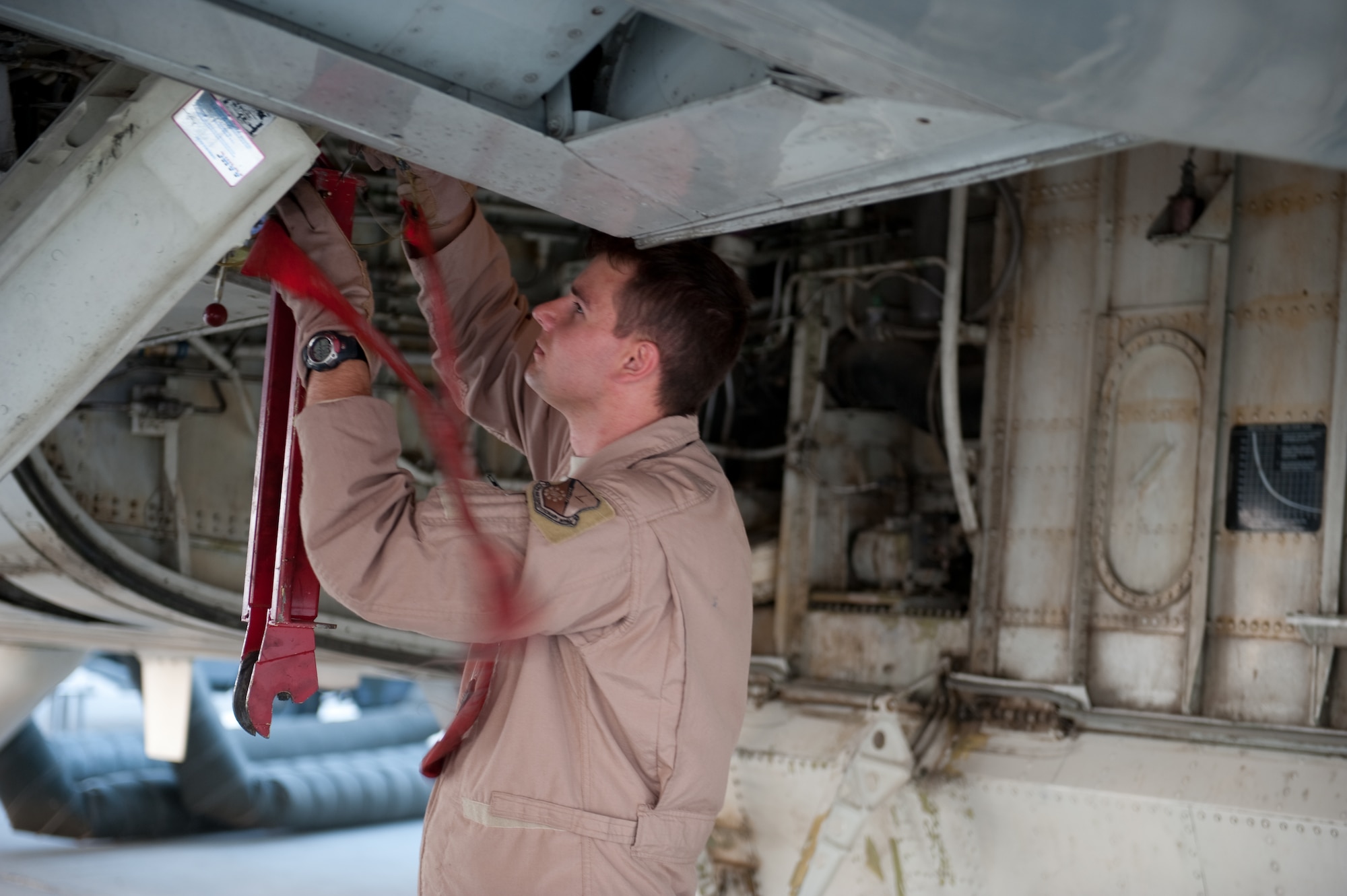 Staff Sgt. Jared Koepp, 7th Expeditionary Air Command and Control Squadron flight engineer, performs a preflight check to ensure an E-8 Joint Surveillance Target Attack Radar System aircraft is safe to fly, Aug. 11, in Southwest Asia. The JSTARS is an airborne battle management, command and control, intelligence, surveillance and reconnaissance platform. Sergeant Koepp is a native of Seguin, Texas, and is deployed from Robins Air Force Base, Ga., in support of Operations Iraqi and Enduring Freedom. (U.S. Air Force Photo/ Staff Sgt. Robert Barney) 