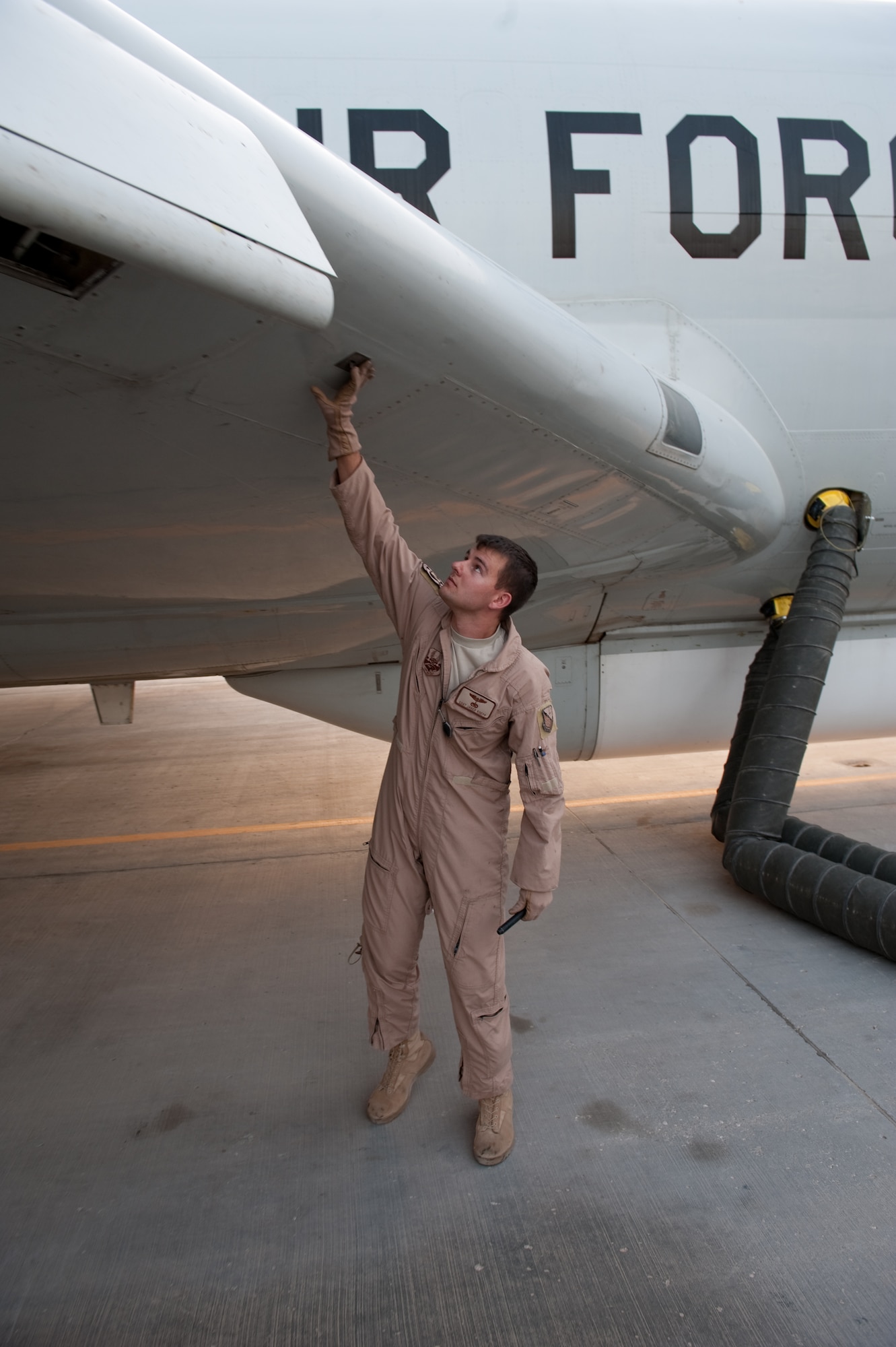 Staff Sgt. Jared Koepp, 7th Expeditionary Air Command and Control Squadron flight engineer, performs a preflight check to ensure an E-8 Joint Surveillance Target Attack Radar System aircraft is safe to fly, Aug. 11, in Southwest Asia. The JSTARS is an airborne battle management, command and control, intelligence, surveillance and reconnaissance platform. Sergeant Koepp is a native of Seguin, Texas, and is deployed from Robins Air Force Base, Ga., in support of Operations Iraqi and Enduring Freedom. (U.S. Air Force Photo/ Staff Sgt. Robert Barney) 