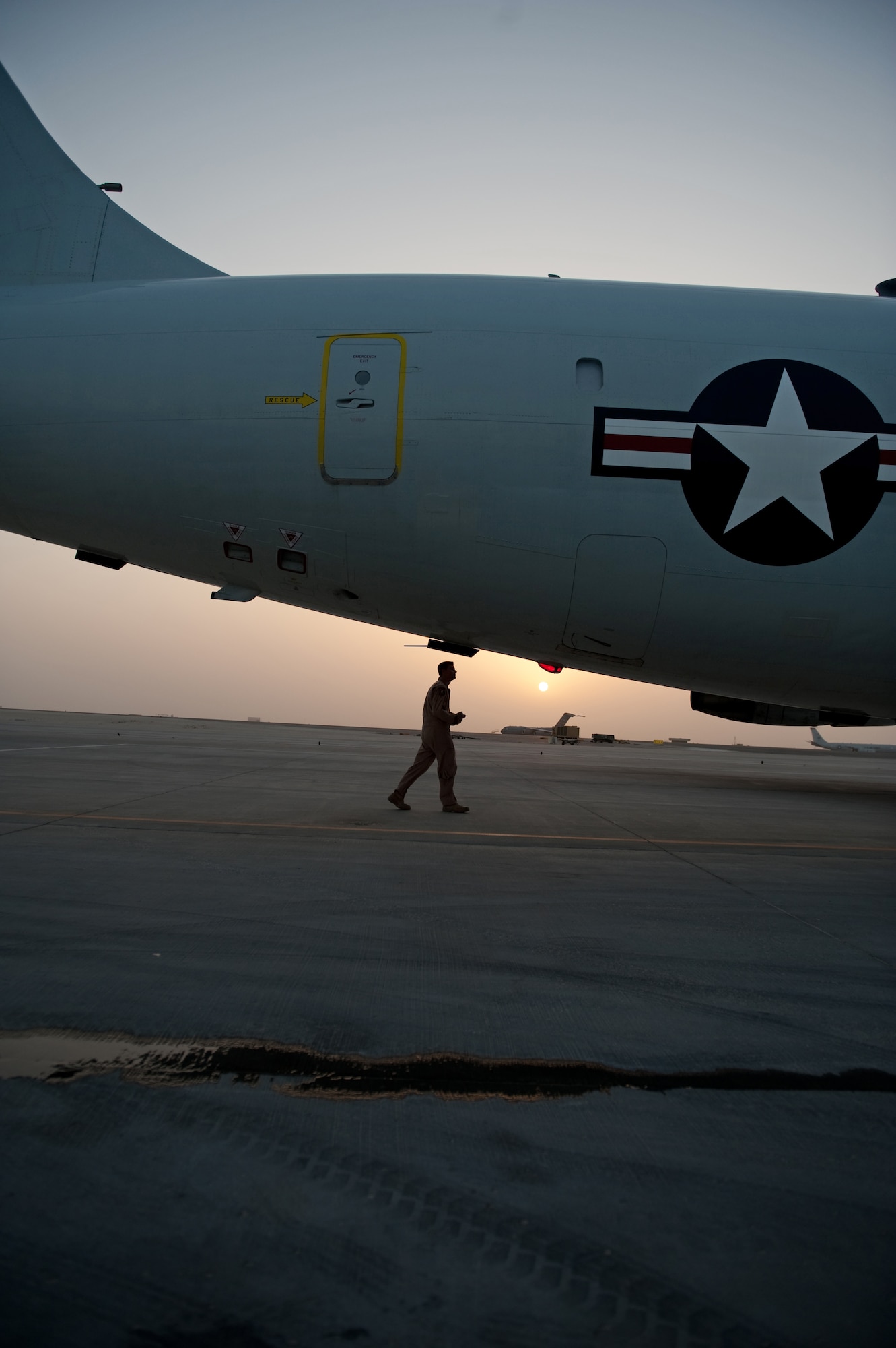 U.S. Air Force Staff Sgt. Jared Koepp, 7th Expeditionary Air Command and Control Squadron flight engineer, performs a preflight check to ensure an E-8 Joint Surveillance Target Attack Radar System aircraft is safe to fly, Aug. 11, in Southwest Asia. The Joint STARS is an airborne battle management, command and control, intelligence, surveillance and reconnaissance platform. Sergeant Koepp is a native of Seguin, Texas, and is deployed from Robins Air Force Base, Ga., in support of Operations Iraqi and Enduring Freedom. (U.S. Air Force Photo/ Staff Sgt. Robert Barney/Released) 