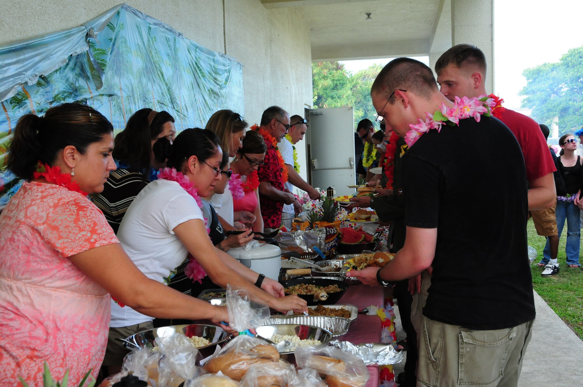 Team Kadena members enjoy food and fellowship during a base wide luau held at the Wire Bean Center, here at Kadena Air Force Base, 13 August, 2009. This event hosted by the base chapel included, outdoor Hawaiian style pig roast, island buffet, and Taiko drummers.  (U.S. Air Force photo/Staff Sgt Lakisha A. Croley)