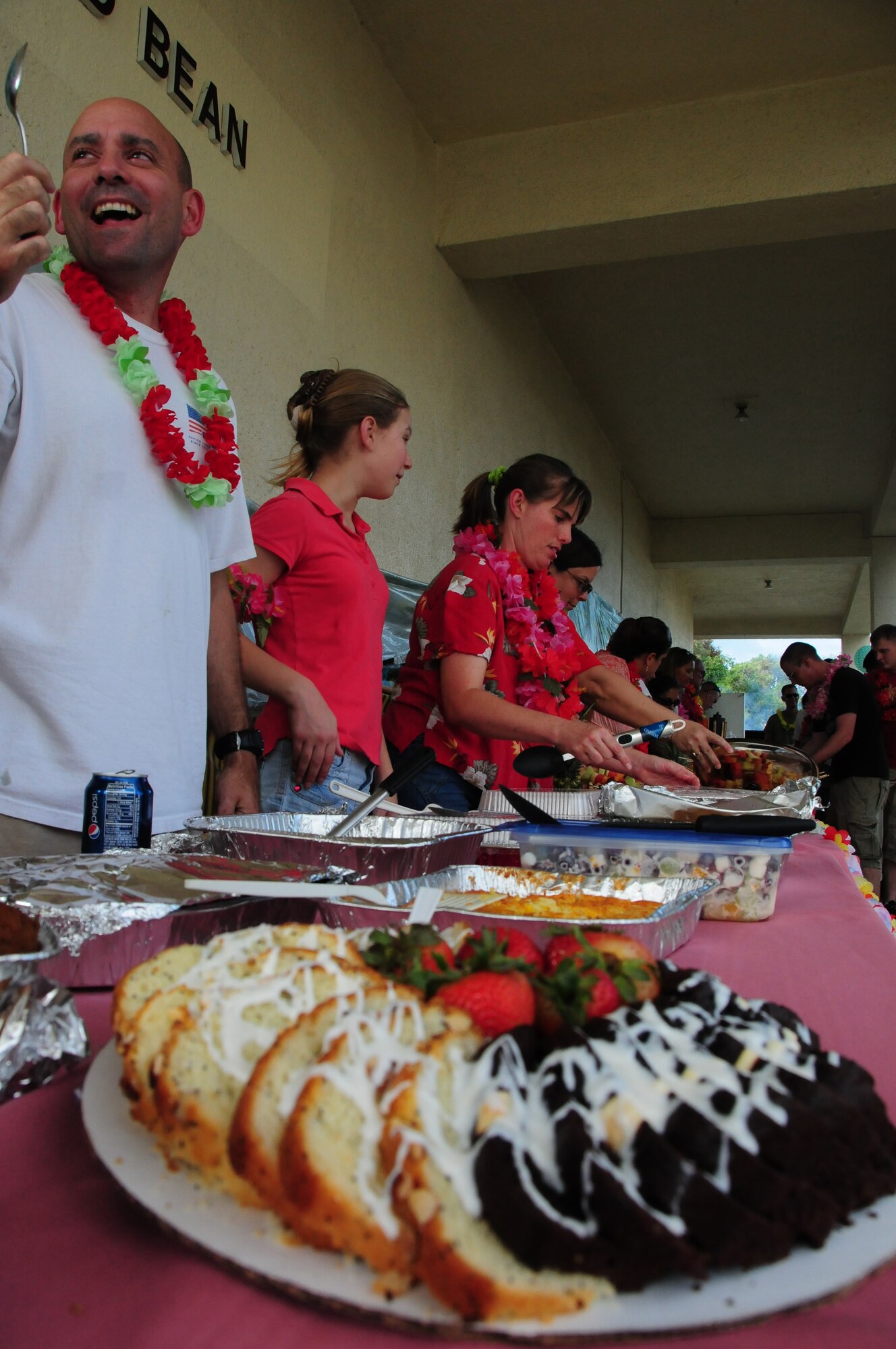 Team Kadena members enjoy food and fellowship during a base wide luau held at the Wire Bean Center, here at Kadena Air Force Base, 13 August, 2009. This event hosted by the base chapel included, outdoor Hawaiian style pig roast, island buffet, and Taiko drummers.  (U.S. Air Force photo/Staff Sgt Lakisha A. Croley)
