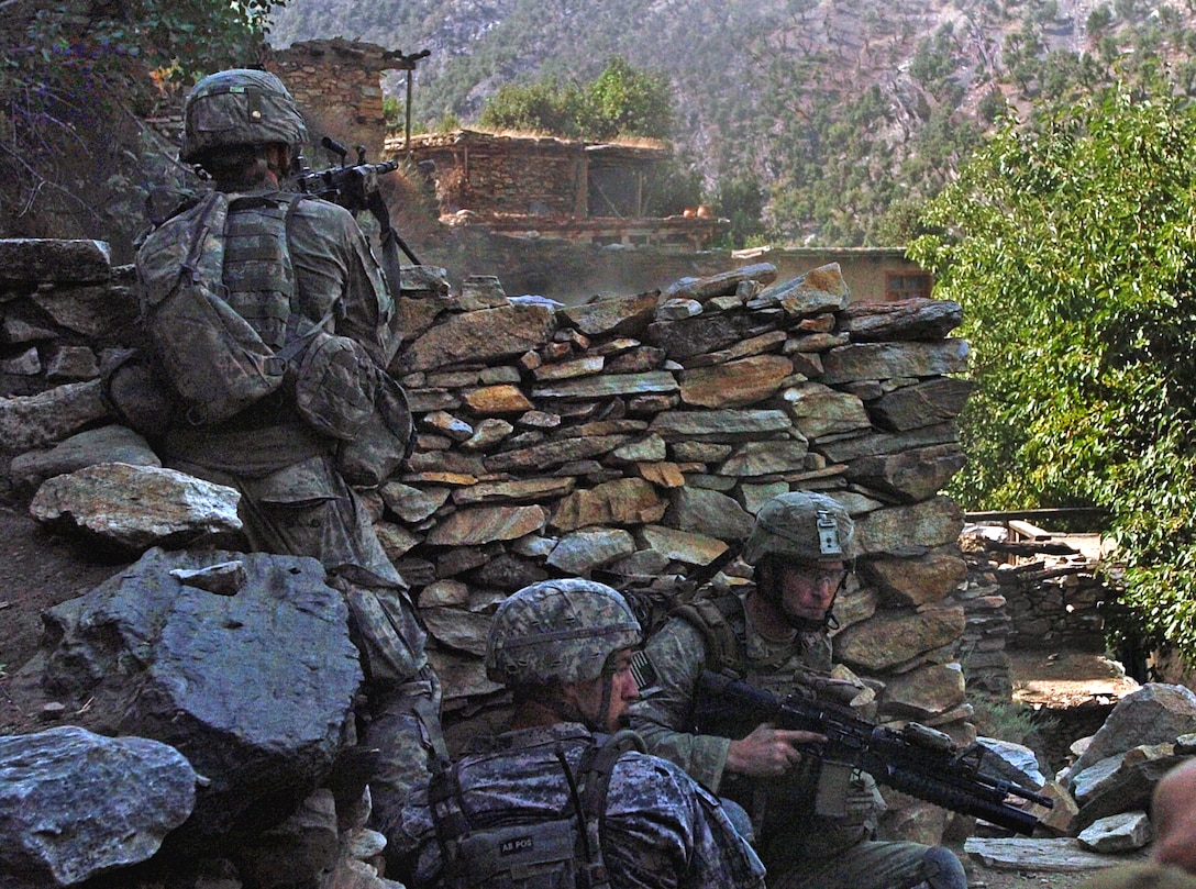 U.S. Army soldiers and Air Force personnel return fire at insurgent positions in the Korengal valley’s steep hillside in Kunar province, Afghanistan, August 13, 2009. The 20-minute gun battle ended with 500 pound bombs, dropped by U.S. Air Force F-15 fighter jets, destroying insurgent positions in the surrounding hills. No civilians were injured.
