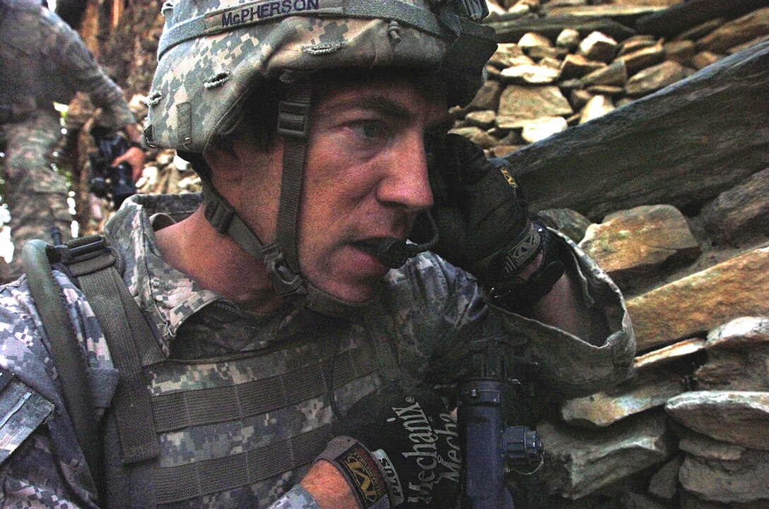 U.S. Air Force Tech Sgt. Joel McPherson calls in an air strike on insurgent positions in the steep hills of Korengal valley in Kunar province, Afghanistan, Aug. 13, 2009. McPherson, a joint terminal attack controller, assigned to the 4th Infantry Division's Company B, 2nd Battalion, 12th Infantry Regiment, 4th Brigade Combat Team, and fellow Air Force airmen fight side by side with their Army counterparts, serving as joint terminal attack controllers, responsible for coordinating air strikes for ground forces.